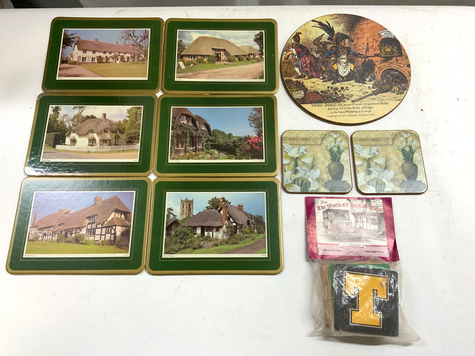 Lot Vintage 34 Asst Placemats & Coasters: Lot includes 6 placemats with different houses including Majesty, Riverdell, White House, Travellers Rest, Tudor House, & Rose Cottage. Lot also includes 1 piece of trademarked LADY CLARE decor TIDDY