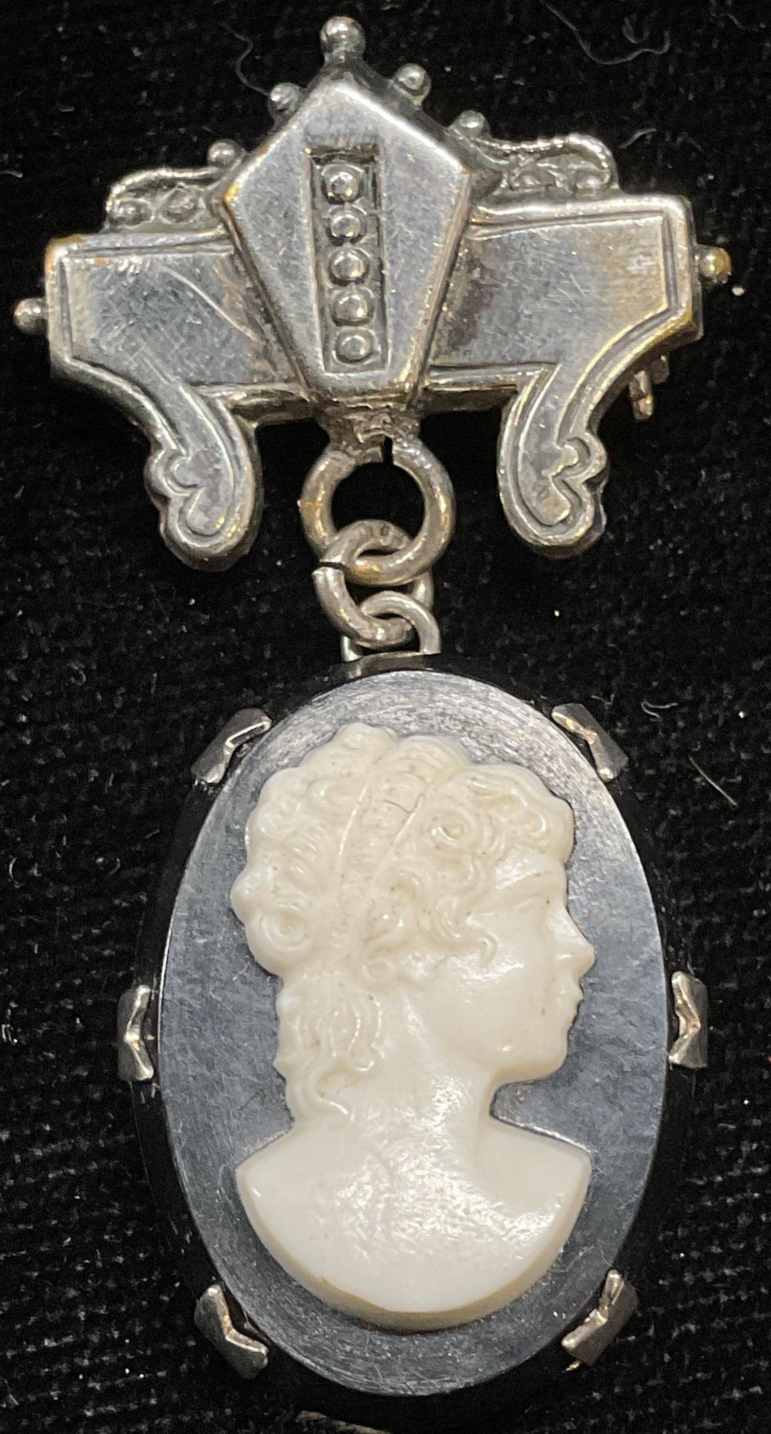 Vintage Silver Tone Lucite Cameo Brooch: Vintage silver tone brooch with black and white lucite cameo. Measures approx 1.75 x 1 inches. Some scratching. Jewelry, estate jewelry, costume jewelry, cocktail jewelry, fashion jewelry, accessories