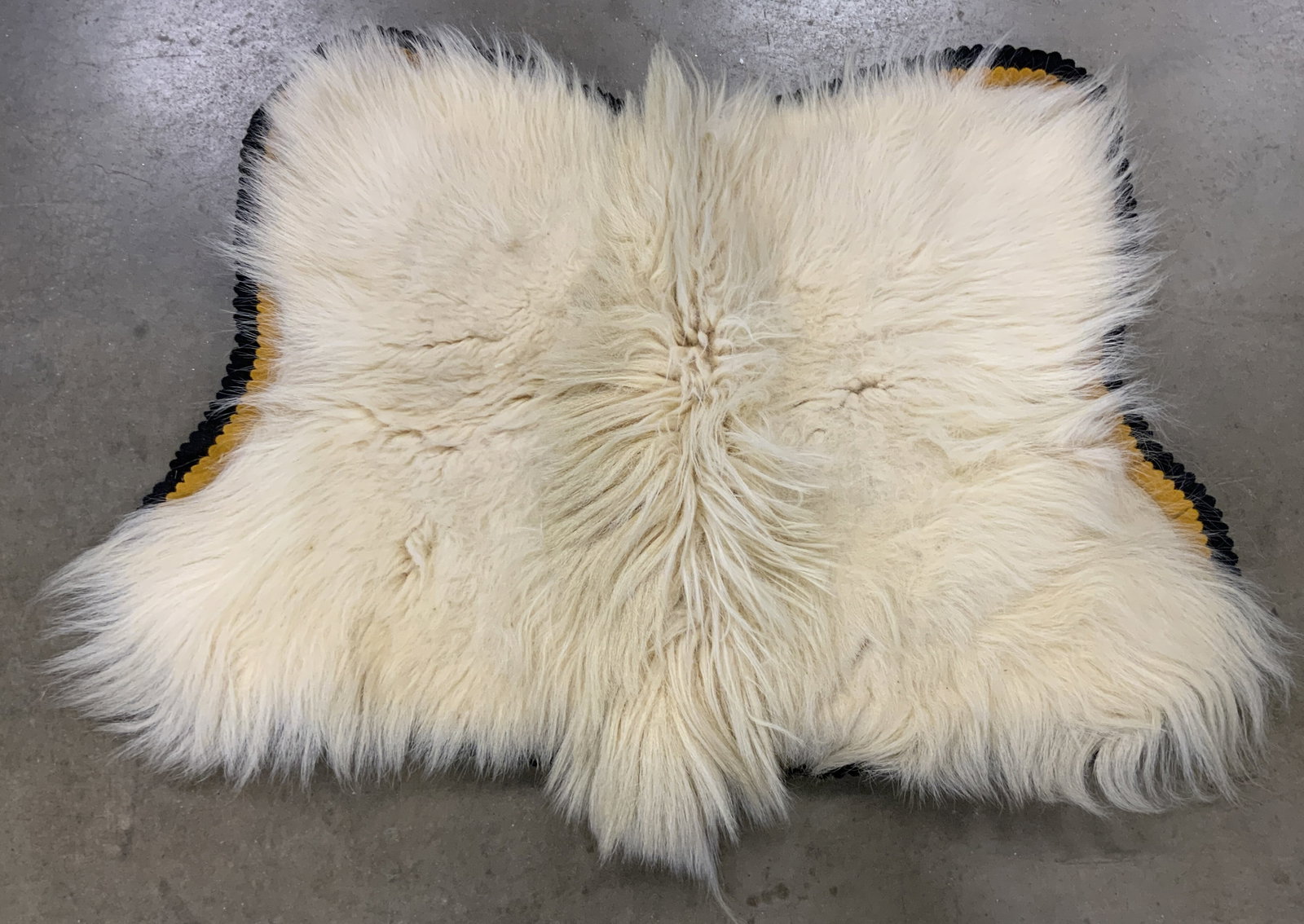 Vintage Cream Toned Fur Rug: Rug is cream toned appears to be crafted from fur. Underside appears to be lined in felt. Piece Measures approx 44 inches long 32 inches wide. Fur, fur rug, carpet, fur carpet, homewares, home decor, 