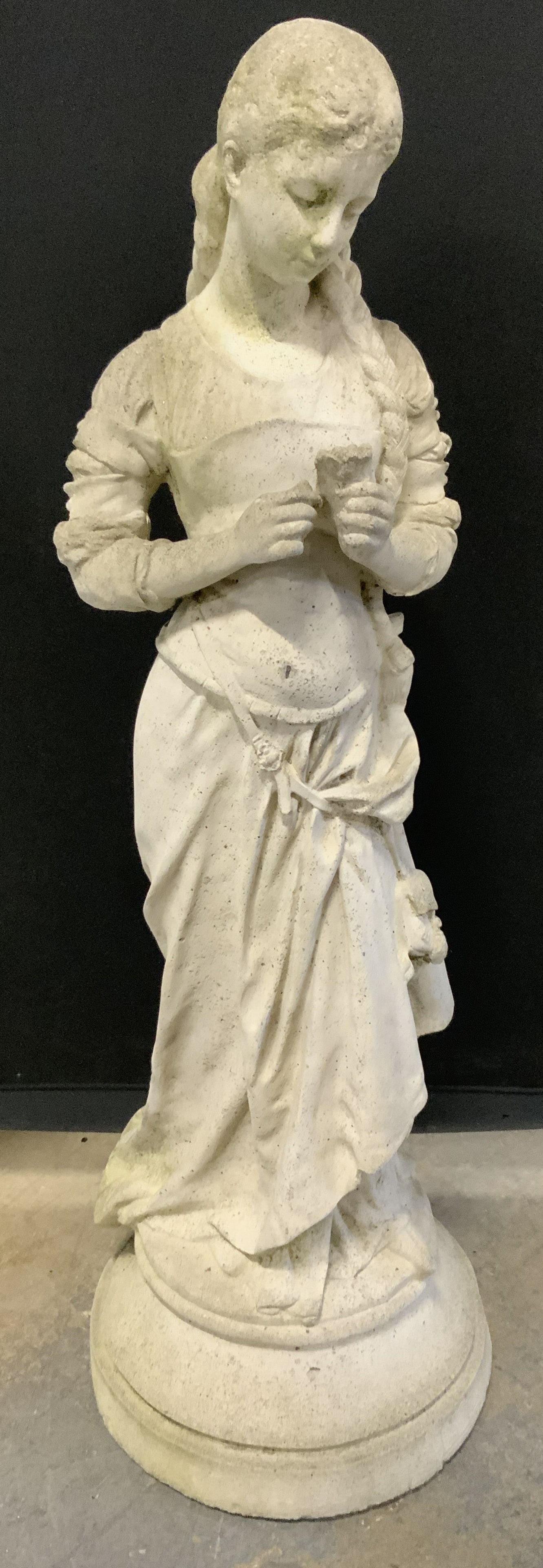 Hippolyte After Francois Moreau Cement Fem Sclp: Statuary is vintage. Piece depict Hippolyte After Francois Moreau. Statuary is cement. Piece depict a female figure with French braid holding a flower. Statuary has circular form base. Piece measures 