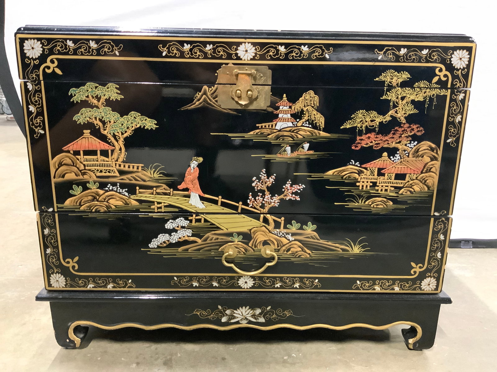 Vtg Asian Chinoiserie Chest W Drawer: Chest is black toned & lacquered. Piece appears to be vintage. Chest has hinged lid and 1 drawer. Piece has intricate Asian architecture, floral, leaf and landscape detail. Chest has chow feet. Lid ne