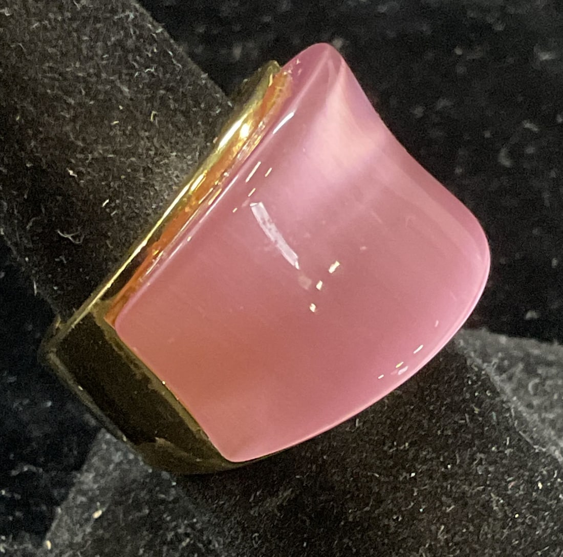 Steel Time Gold Plated Pink Glass Ring: Steel Time ring. Gold plated stainless steel band with iridescent pink glass cabochon. Signed on band. Ring size 7. Some scratching observed. Jewelry, estate jewelry, costume jewelry, cocktail jewelry