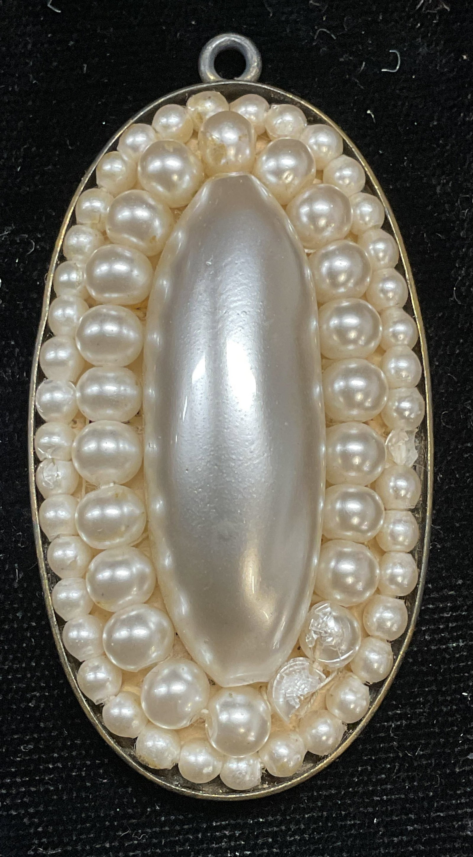Vintage Reproduction English Faux Pearl Pendant: Vintage reproductions of an antique English pendant. Large oblong faux pearl surrounded by smaller round faux pearls in silver plated setting. Engraved on the underside, An Ornament Worn By The Counte