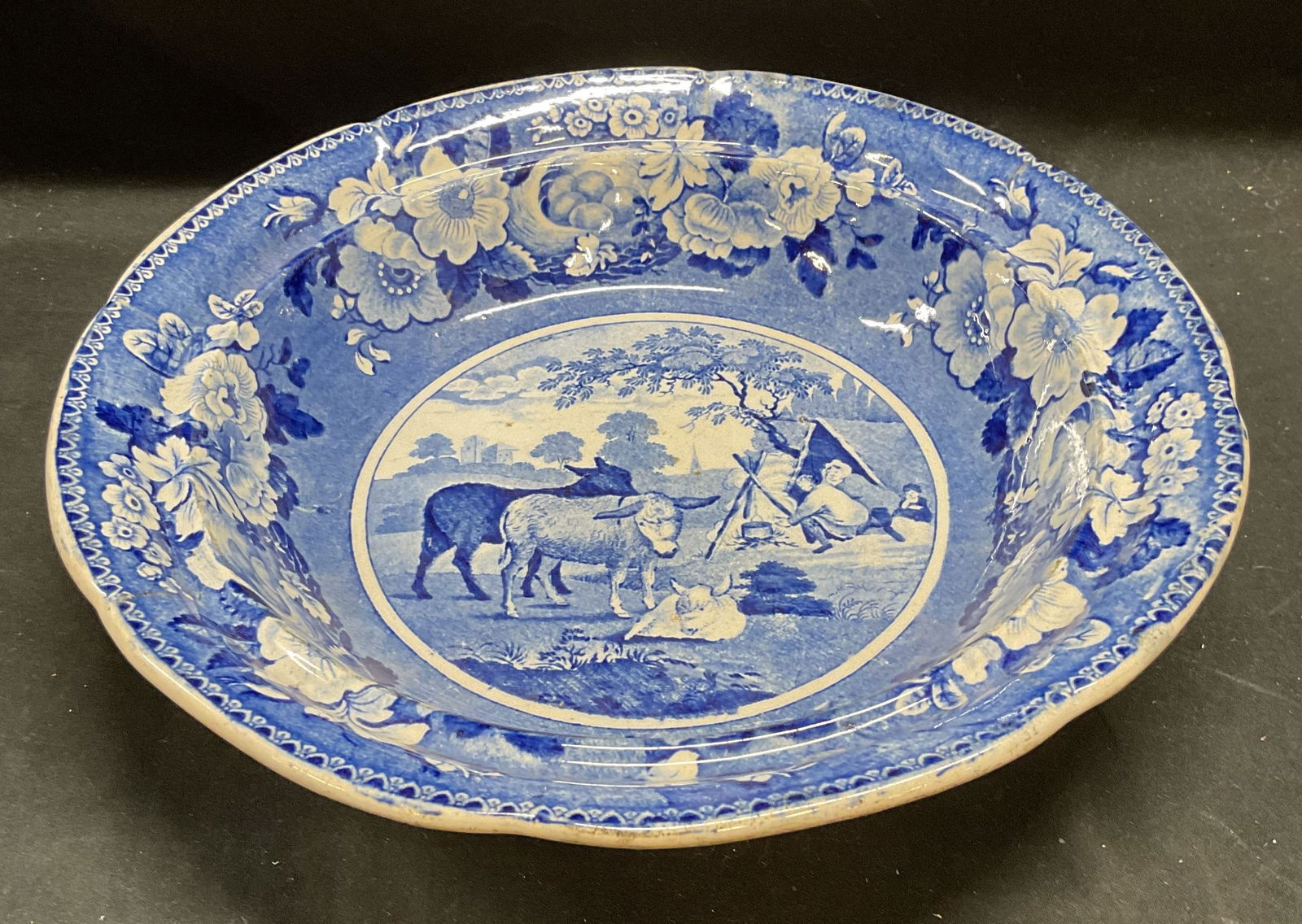 Antique Careys Domestic Cattle Pottery Bowl: Antique pottery bowl. Attributed to English pottery manufacturer Careys. Domestic Cattle pattern, labeled on underside. Blue Transferware with figural and cattle scene and decorative floral border. An