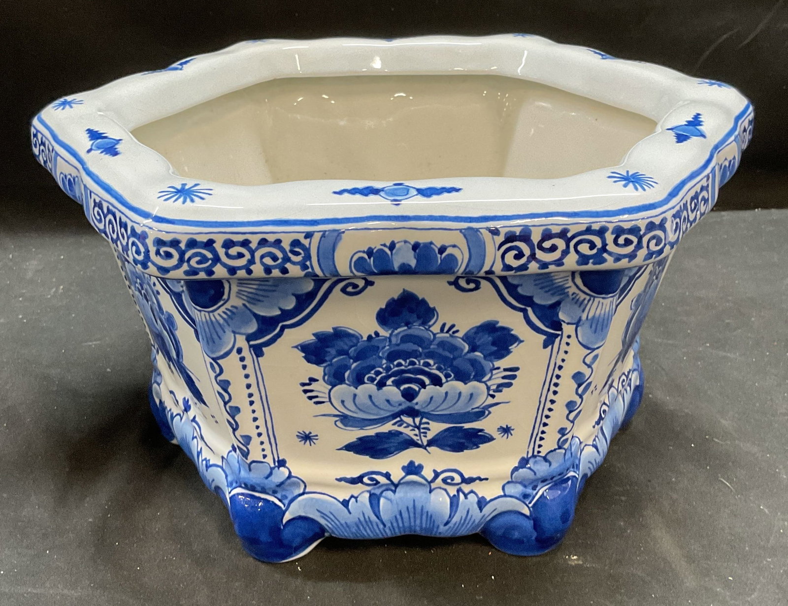 Signed Delft Blue Porcelain Floral Planter: Signed delft porcelain planter, signed on underside, reads Delft 1888 MVT CR. Additional marks illegible. Hexagon shape with curved footed base and curved lip. Measures approx 11 x 10 x 6 inches. Some