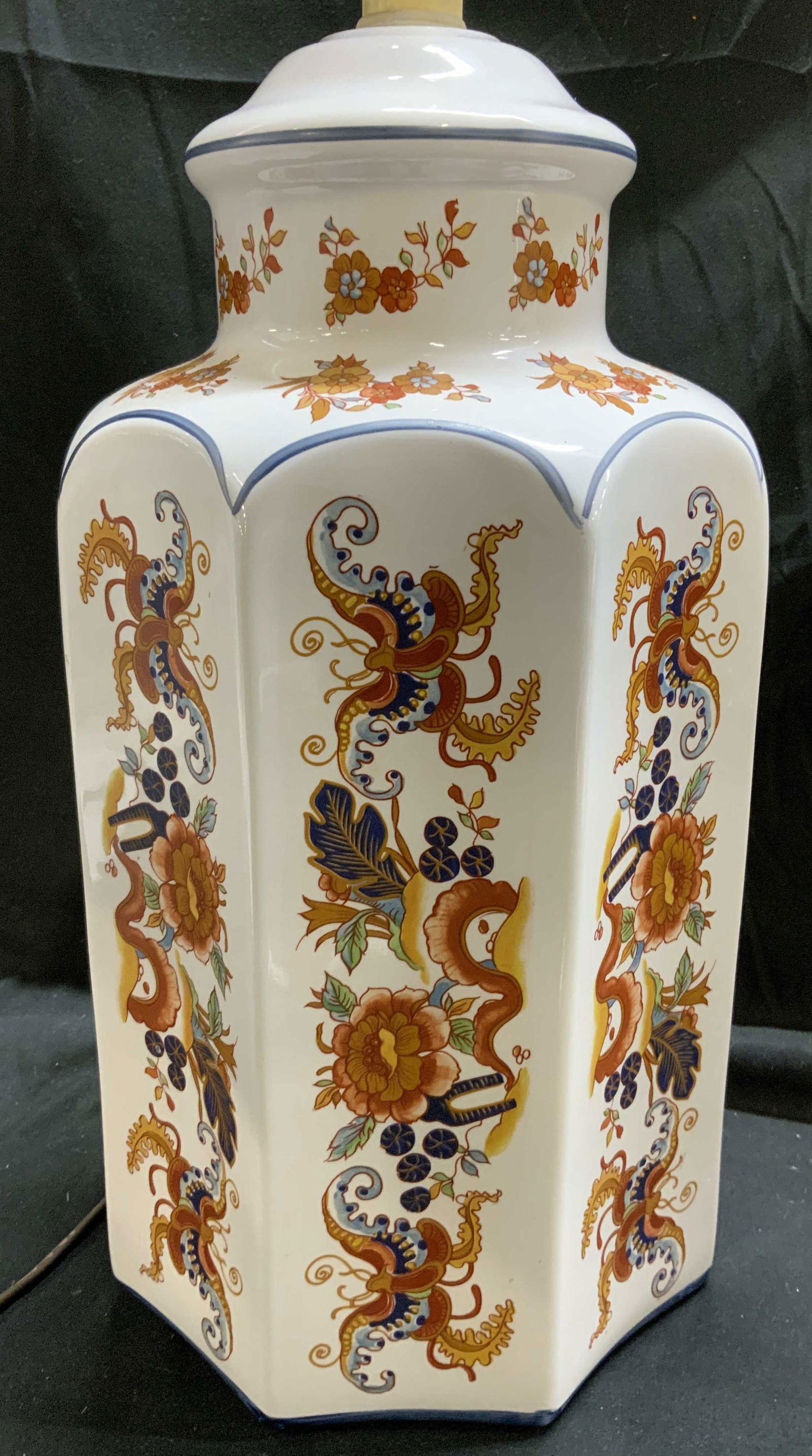 Vintage Octagonal Asian Porcelain Tbl Lamp: Lamp is vintage. Piece is white toned and porcelain with intricate multi toned floral, butterfly, leaf & traditional Asian motif detailing. Lamp has octagonal form. Piece includes harp and finial. Lam
