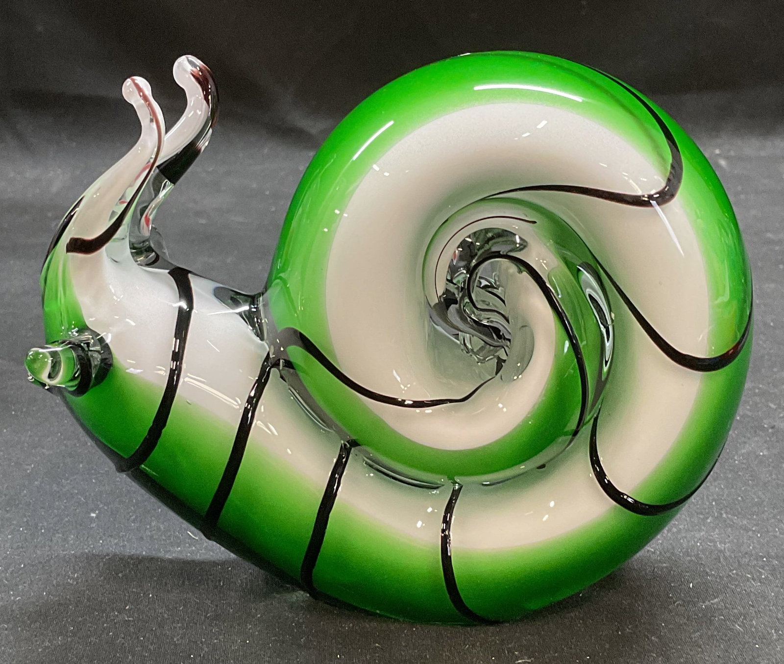 Hand Blown Green White Art Glass Snail Figural: Hand blown art glass snail motif figural. Green and white swirl with applied black cane stripe. Measures approx 5 x 2.5 x 4 inches. Some scratching. Art glass snail, snail figural, collectibles, decor