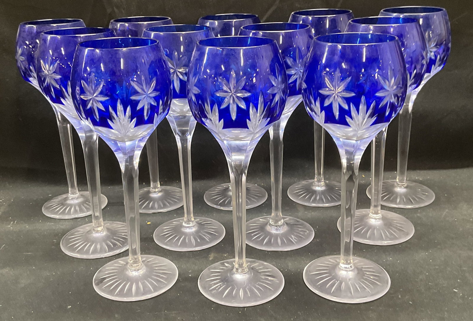 12 RB Cobalt Clear Crystal Wine Glasses Germany: Set of 12 signed RB cobalt to clear cut crystal wine glasses. Signed on underside. Made in Germany. Starburst patterns. Measures approx 3 x 8.5 inches. Some wear to all pieces including minor scratchi