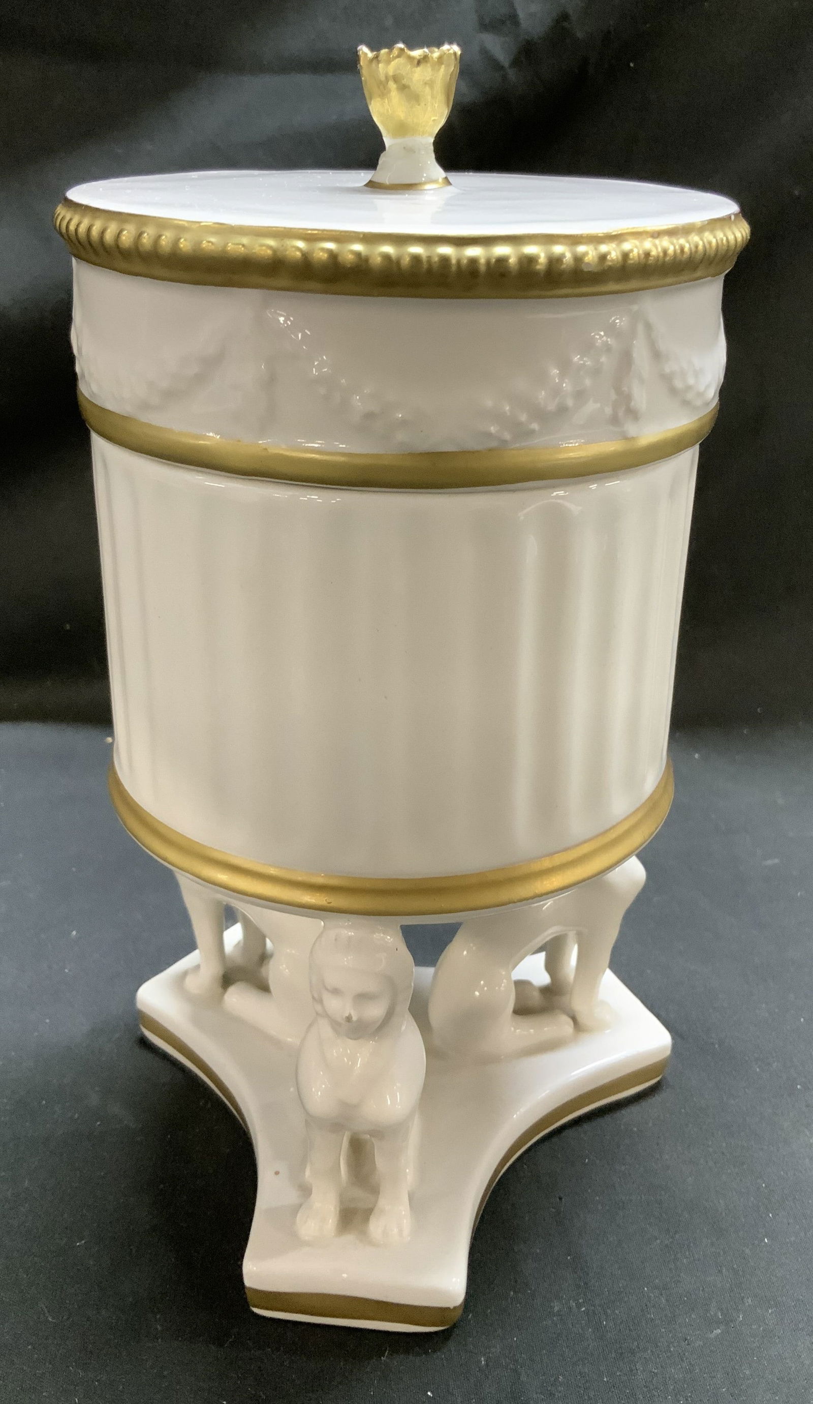 Vntg A Mottahedeh Design Neoclassical Urn ITALY: Urn has a neoclassical style, featuring a fluted cylindrical body adorned w gold accents. Lid is topped w a gilt finial. Bottom of urn features 3 Sphinx figures. Appears to be possible material. Signe