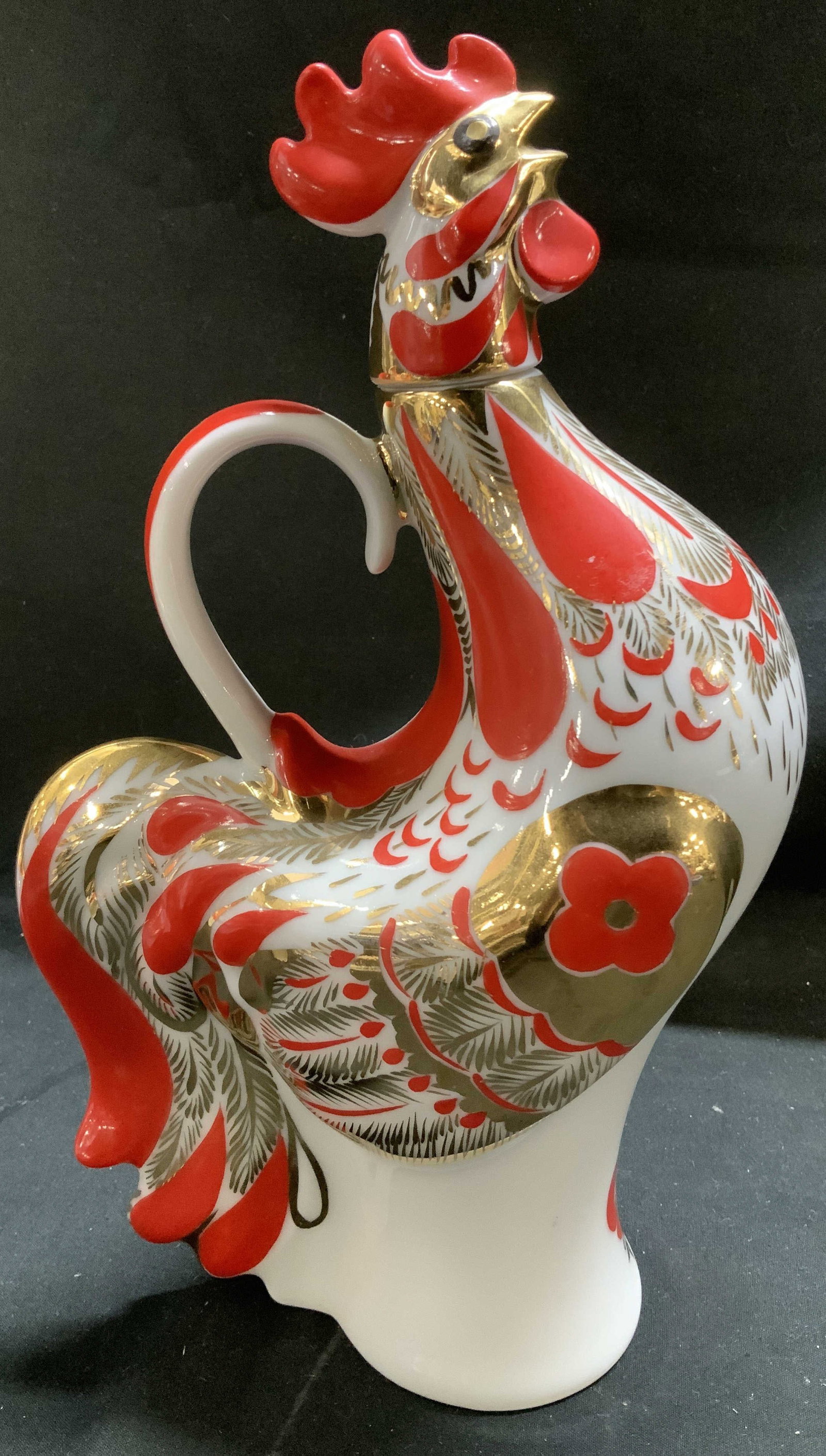 Lomonosov Porc Red Rooster Decanter RUSSIA: Decanter is porcelain material & features hand-painted gilt details. The roosters head acts as a stopper for the decanter. Surface wear consistent to age, use & exposure. Signed & marked on underside.