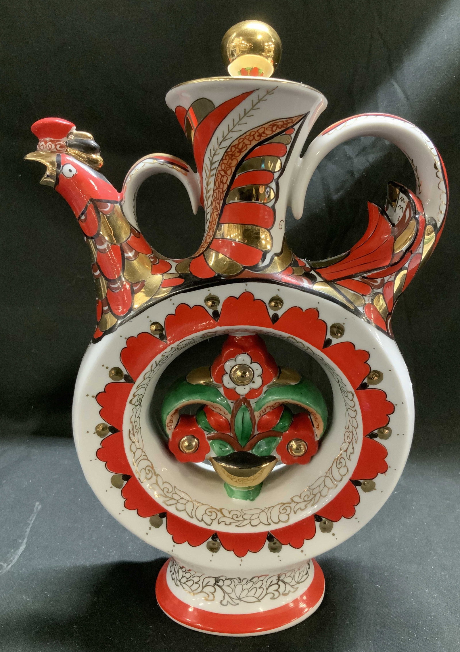 Lomonosov Porc Whistling Rooster Decanter RUSSIA: Decanter is porcelain material & features hand-painted gilt details. Floral motifs in the center. Roosters head & tail feathers serves as handles. Surface wear consistent to age, use & exposure. Signe