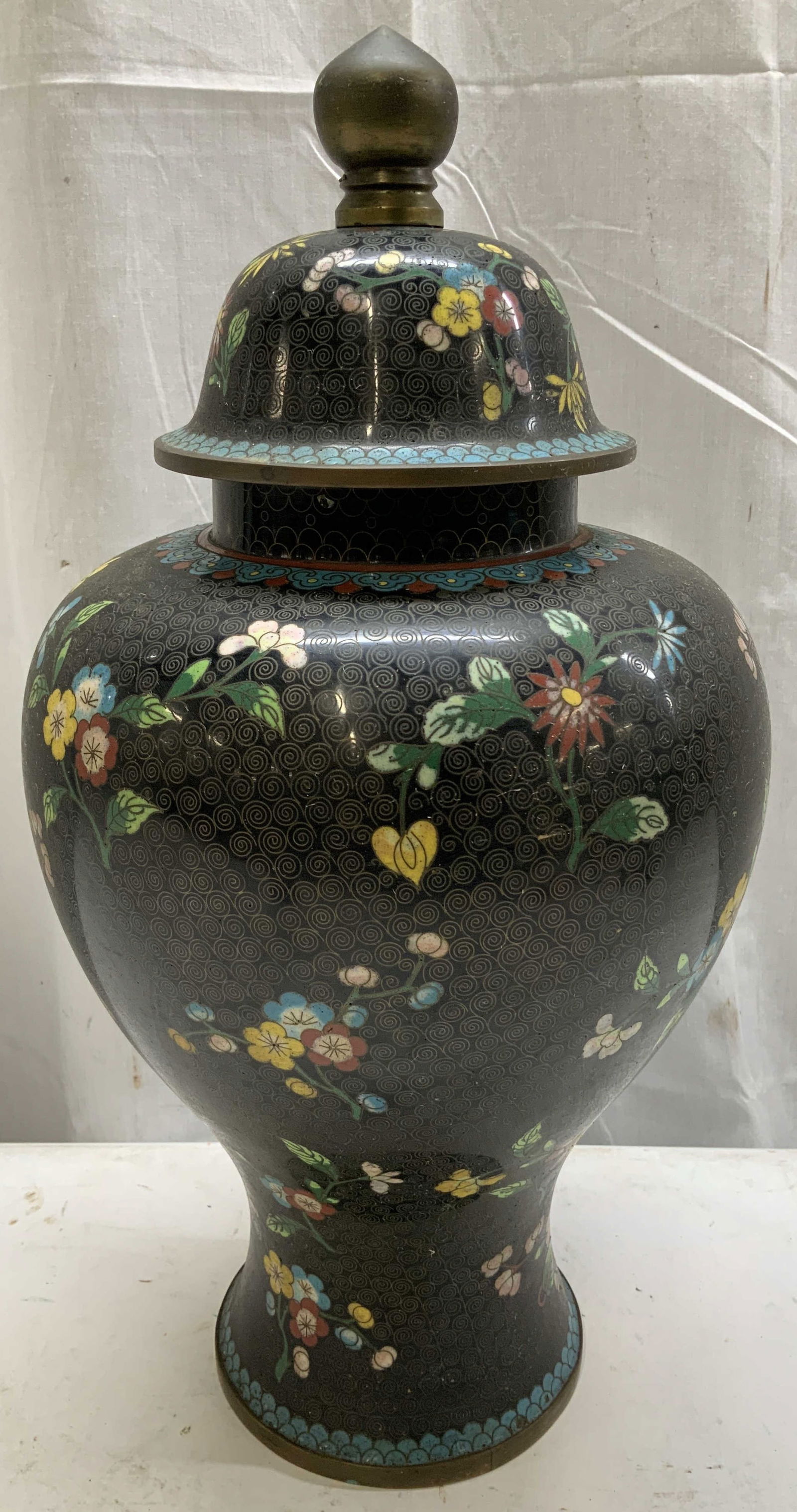 Vintage Chinese Cloisonne Floral Lidded Jar: Jar features floral motifs in shades of blue, yellow, red & green. Jar has a round body w a domed lid topped w a circular finial. Jar is enamel. Surface wear consistent to age, use & exposure. Measure