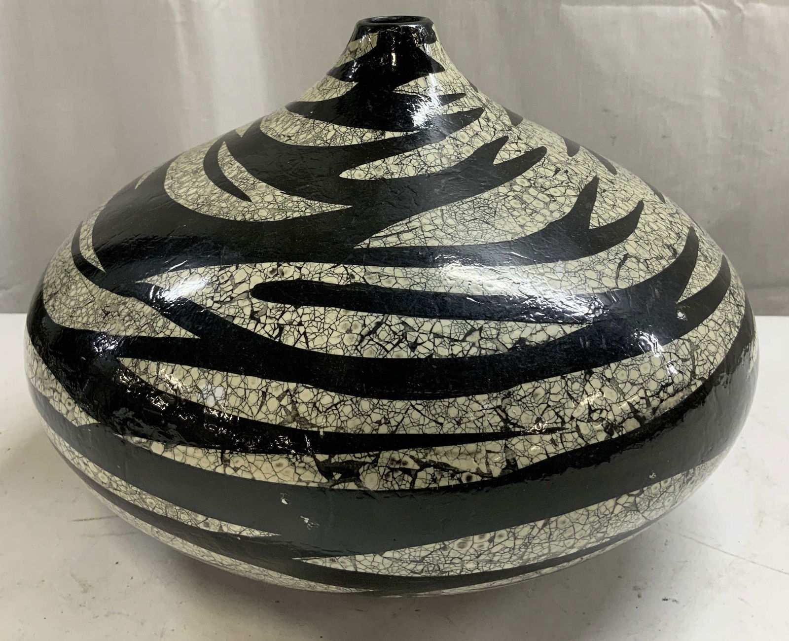 Abstract Black & White Crackle Glaze Vase: Vase features a round body w a narrow neck. Surface is finished in a black & white crackle glaze w an abstract pattern. Piece is ceramic. Surface wear consistent to age, use & exposure. Measurements: