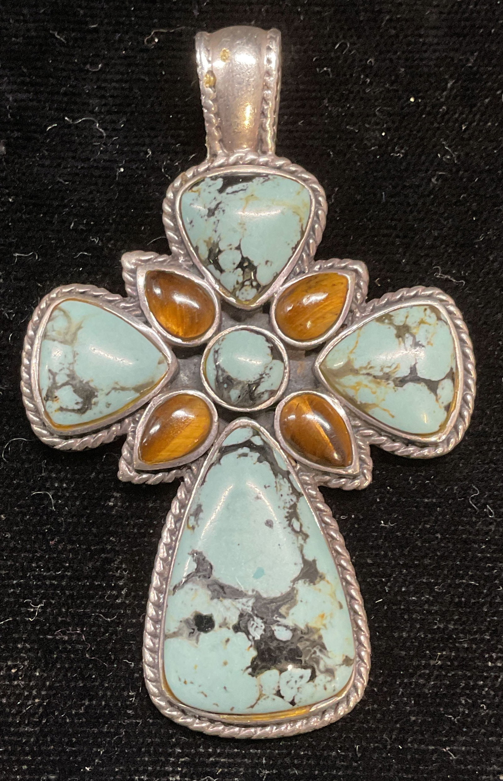 CFJ Sterling Silver Tigers Eye Cross Pendant: Signed CFJ sterling silver cross pendant with blue glass and tigers eye cabochons. Marked sterling. Measures approx 2 x 1.5 inches. Total weight 15.5 grams. Some scratching. Jewelry, estate jewelry, c