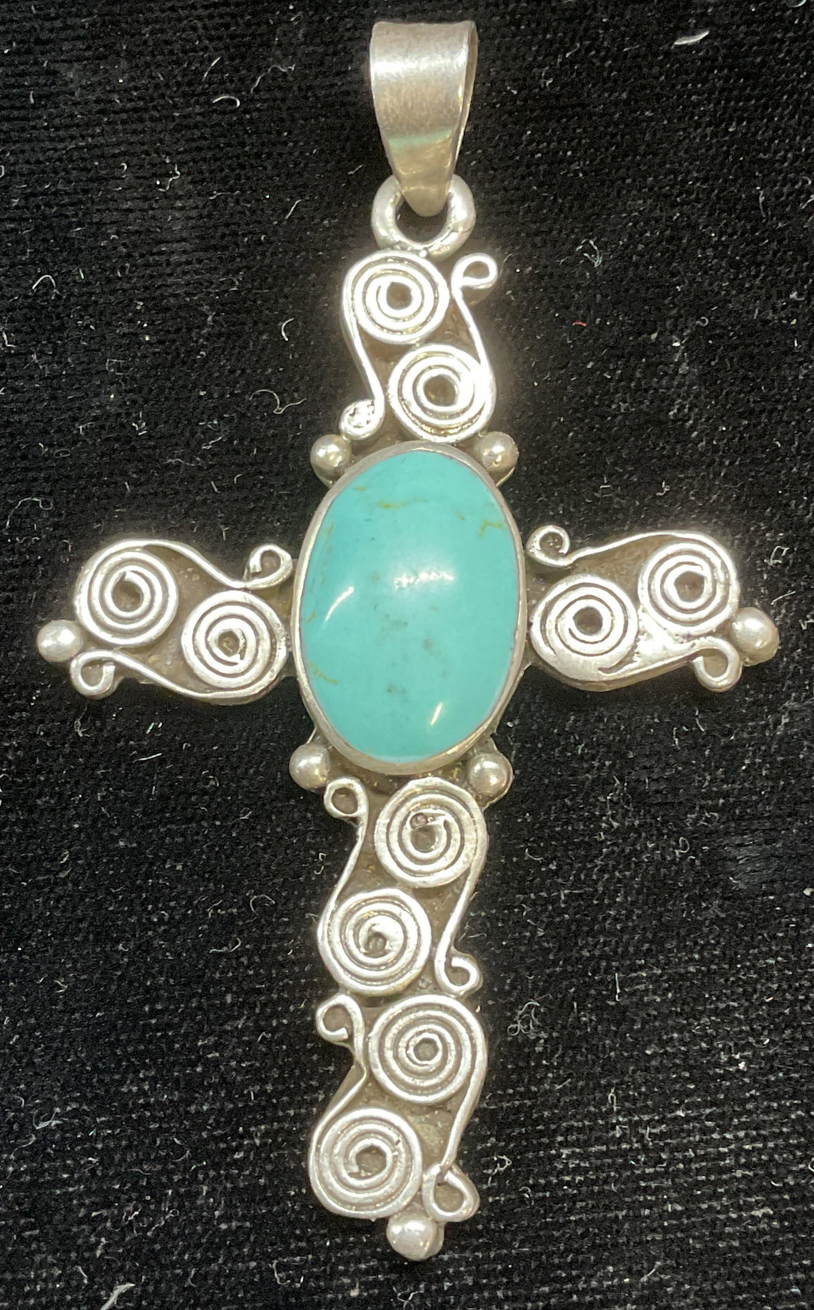 Sgnd Sterling Silver Turquoise Cross Pendant Mexico: Signed Sterling silver and turquoise cabochon cross pendant. Signed illegibly. Made in Mexico. Marked sterling. Measures approx 2.5 x 1.25 inches. Total weight 18.3 grams. Some scratching. Jewelry, es