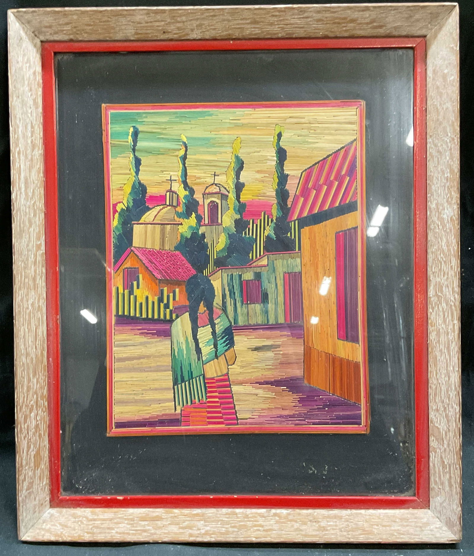 Framed Village Scene Mexican Folk Art Popotillo: Framed and matted Mexican folk art popotillo. Dyed straw mosaic. Village scene with woman and buildings. Wood frame. Not examined out of frame. Frame measures approx 15.5 x 12.75 inches. Some pieces l