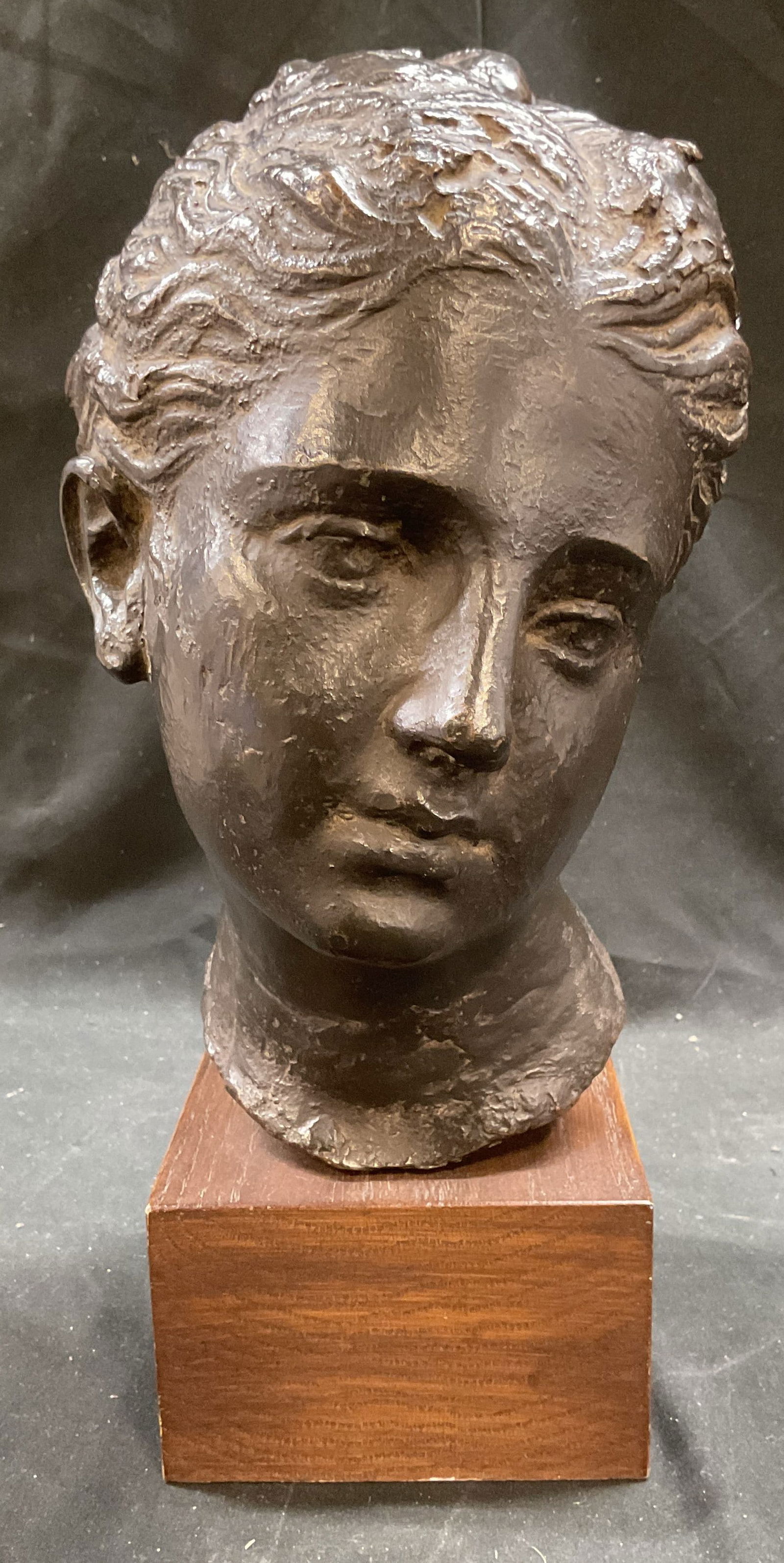 1982 MMA Bronzed Head of a Woman Sculpture: Vintage c. 1982 bronzed sculpture on wood plinth. Copyright marked on reverse MMA, 1982. Museum of Modern Art. Head of a young woman or goddess. Sculpture is heavy. Measures approx 5 x 7 x 13 inches.