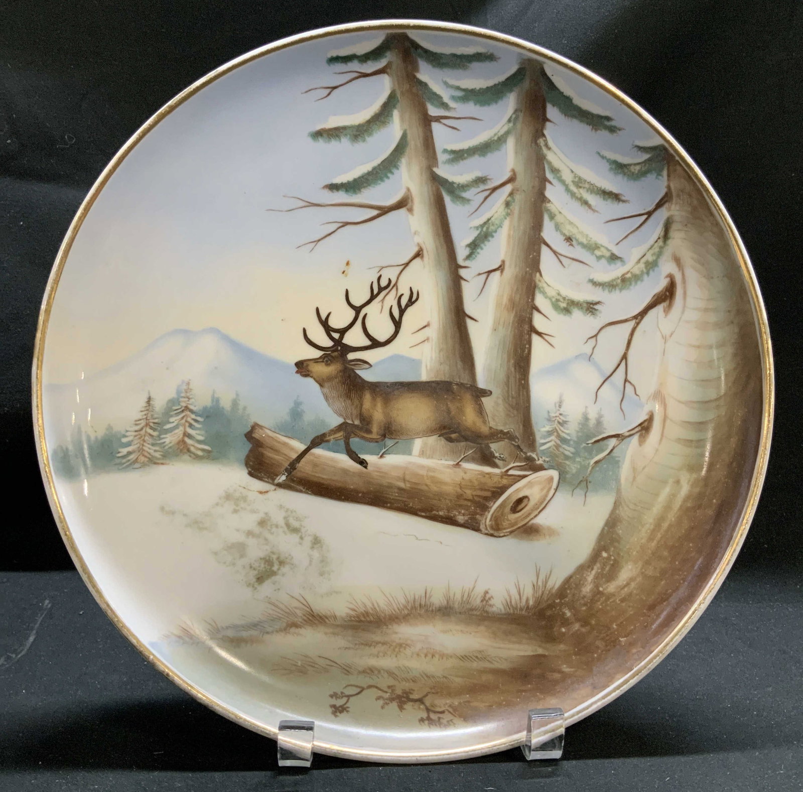 Vntg TK Hand Painted Stag Motif Porcelain Plate: Piece is porcelain & depicts a hand-painted scene of a stag leaping over a log & a forest background. Gold trim. Signed & marked on underside. Reads, TK 33. Surface wear consistent to age, use & expos