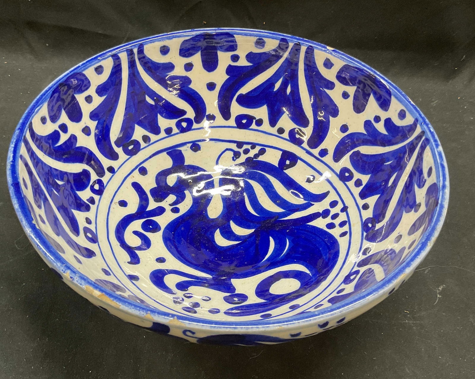 Vintage Blue & White Ceramic Griffin Bowl: Vintage ceramic bowl. Hand painted blue and white with griffin or dragon motif and decorative border. Measures approx 9.5 x 4 inches. Wear including crazing and some chips to glaze. Ceramic bowl, blue