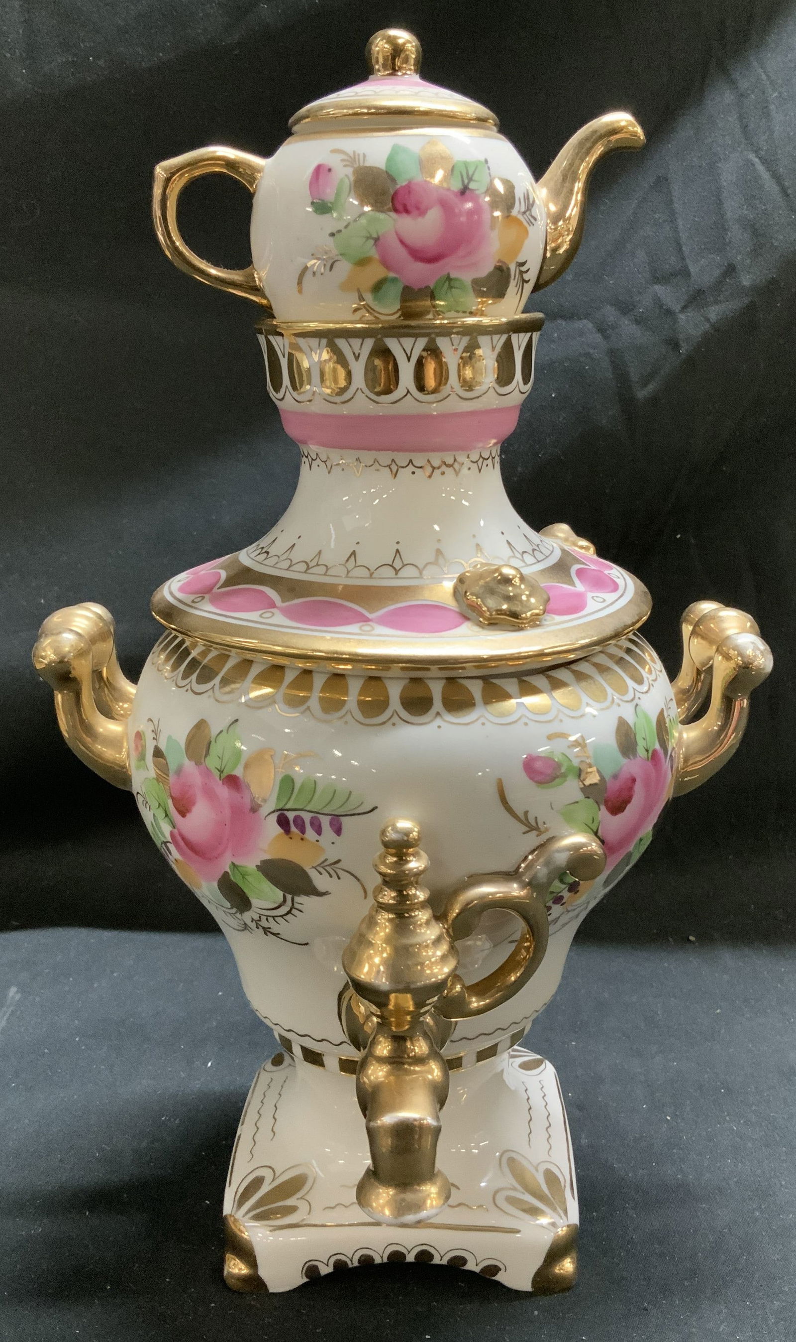 Sgnd Hand Painted Porc Samovar Set W Gilt Accents: Two piece porcelain samovar set featuring a lidded teapot resting atop a samovar base w ornate gilt handles. Hand-painted floral details. Signed on underside. Surface wear consistent to age, use & exp