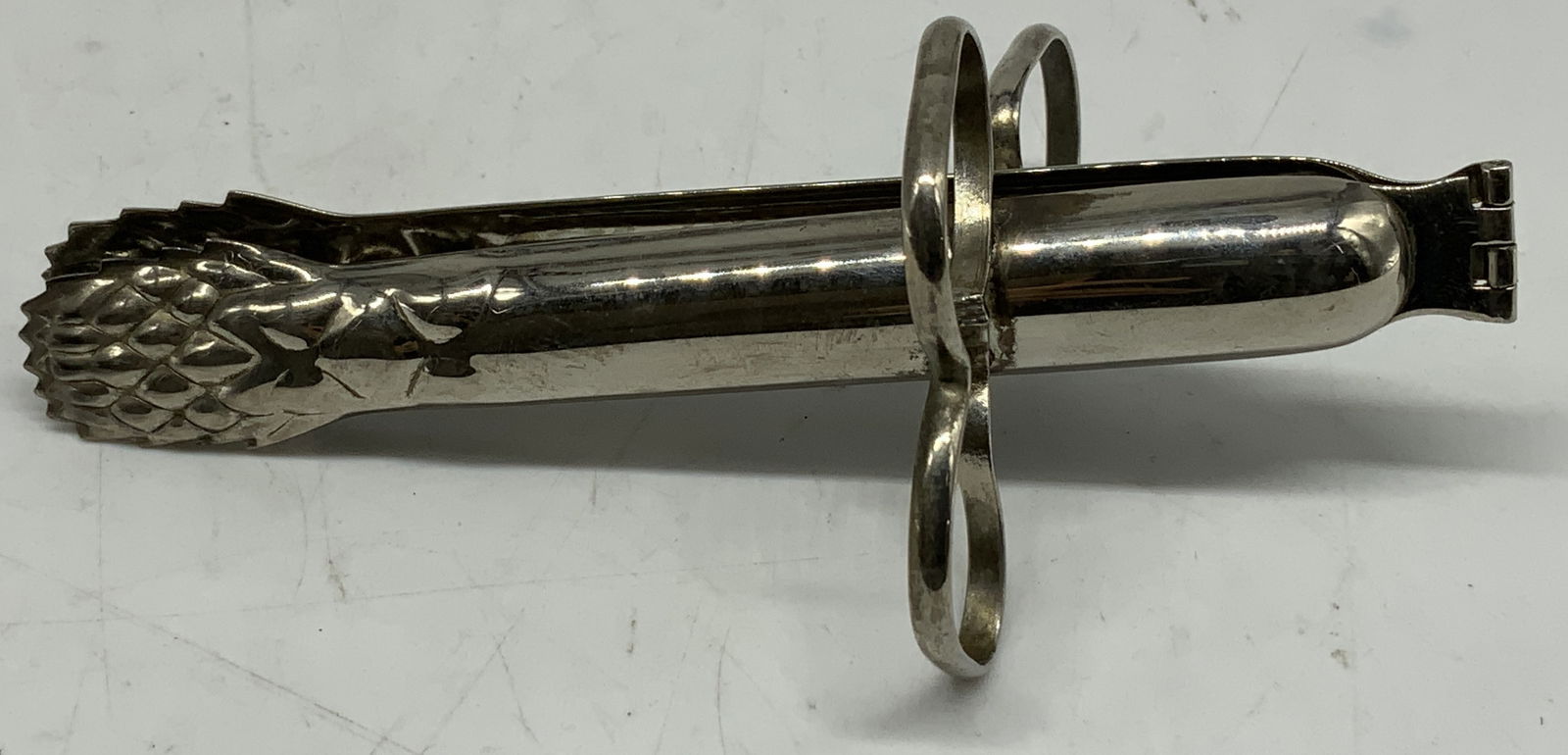 Vintage Silver Plated Asparagus Tongs: One side of tongs is shaped like an asparagus stalk & are designed for serving asparagus spears and feature a hinged design with three rings for a secure grip. Silver plated. Surface wear consistent t