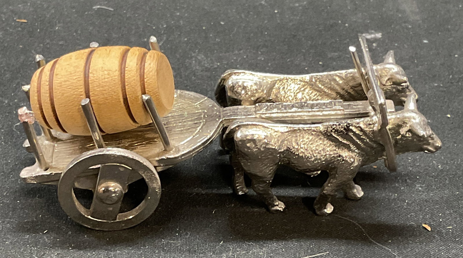 Silver Tone Ox Cart & Barrel Figurine, Portugal: Silver tone ox and cart figurine with wood wine cask barrel. Made in Portugal. Measures approx 3.75 x 1.5 x 1.5 inches. Some wear consistent with exposure. Ox, wine casket, barrel, cart, ox figurine,