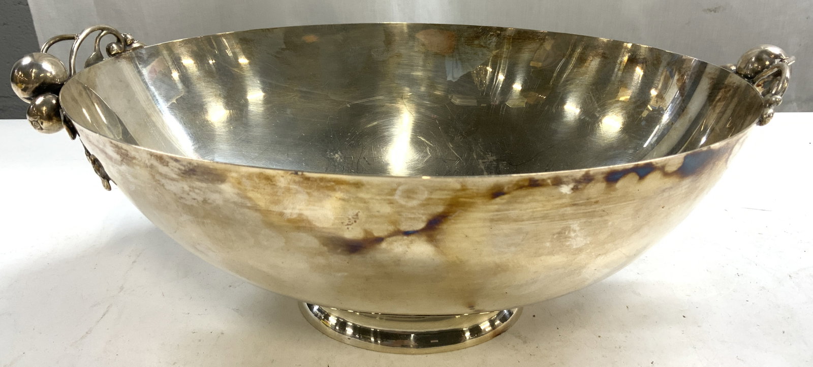 WEBSTER WILCOX INTL SILV CO Silv Pl Silv Apple Bwl: Underside is inscribed WEBSTER WILCOX INTERNATIONAL SILVER CO. Bowl is silver plated. Piece known as the Silver Apple Bowl. Vessel has oval form. Piece has apple and vine form handles. Bowl is vintage