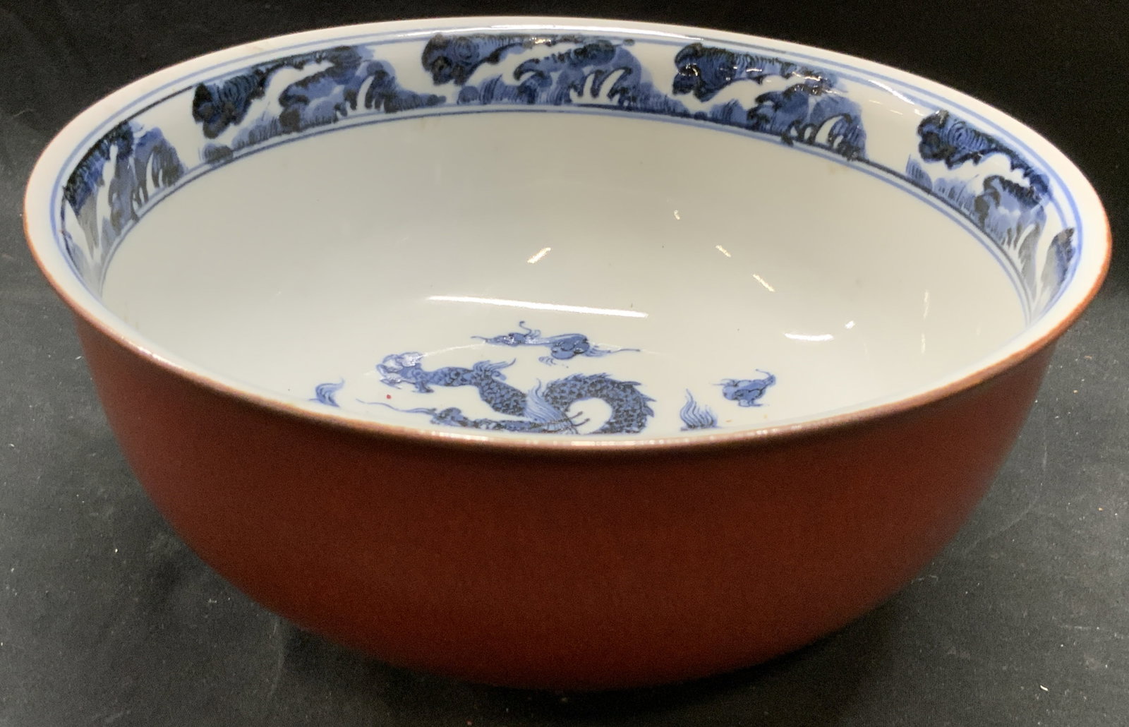 FITZ & FLOYD Flying Dragon Round Vegetable Bowl: Underside is marked FITZ & FLOYD INC. Bowl is porcelain. Piece has red toned exterior. White interior with navy blue toned flying dragon detail. Bowl appears to be vintage. Piece measures approximatel