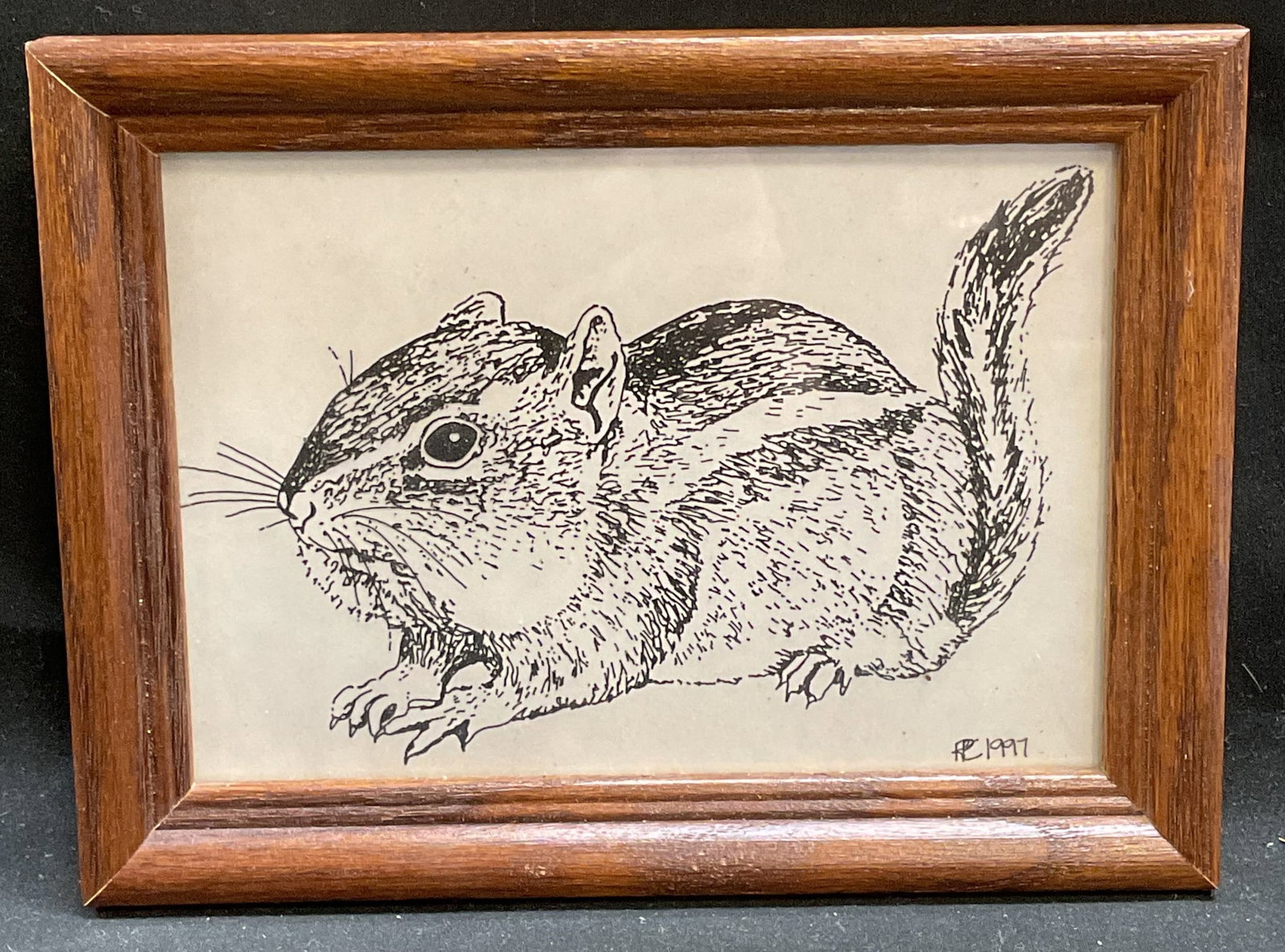 Framed 1997 RPC Squirrel Print: Framed print on plastic sheet. Signature in print lower right RPC. Dated 1997. Wood frame. Not examined out of frame. Frame measures approx 6 x 8 inches. Some wear consistent with exposure. Art, frame
