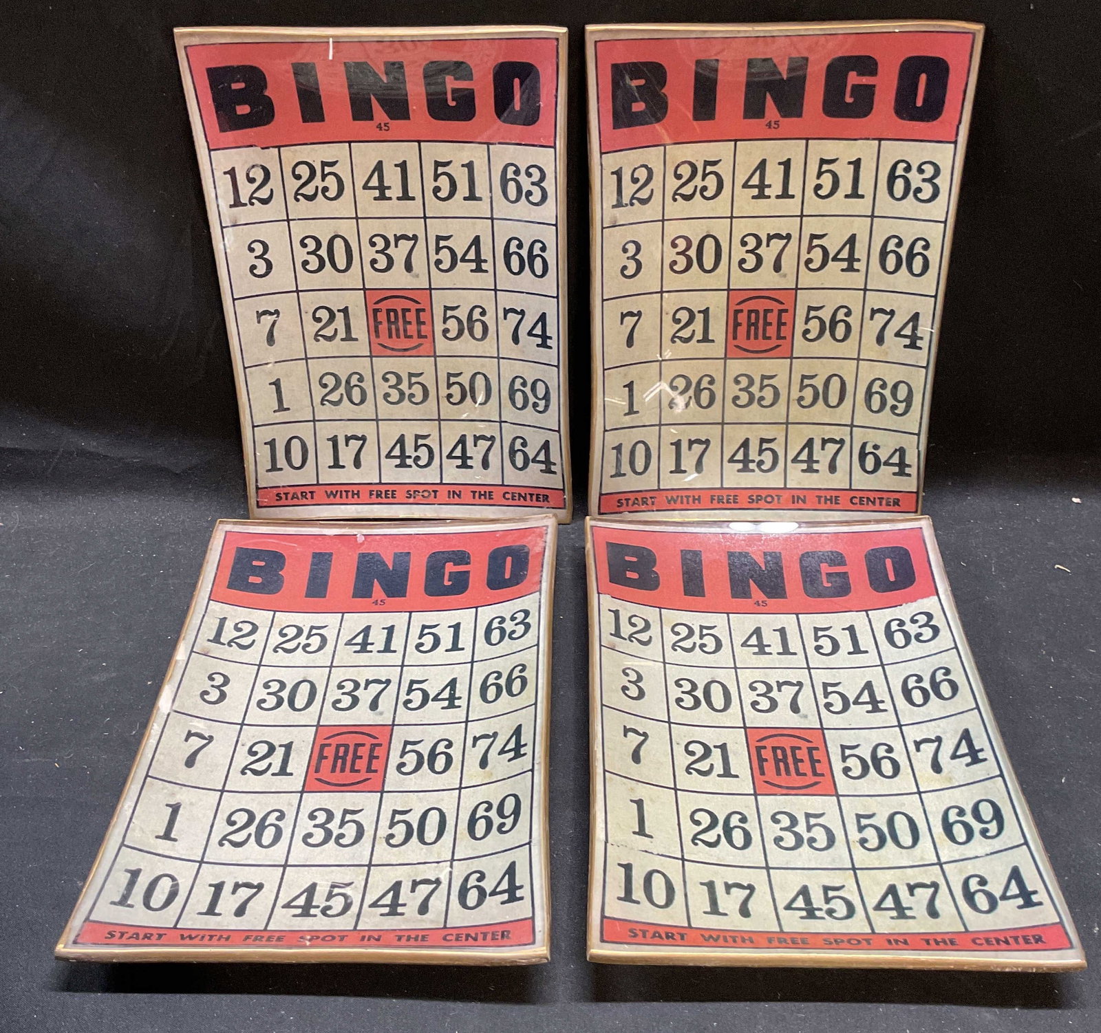 Set 4 Twos Company Gold Leaf Glass Bingo Plates: Set of 4 Twos Company glass Bingo plates. Decoupage Bingo board with gold leaf under glass to underside. Signed on label. Measure approx 8.5 x 6 inches. Some wear including scratching. Twos company pl