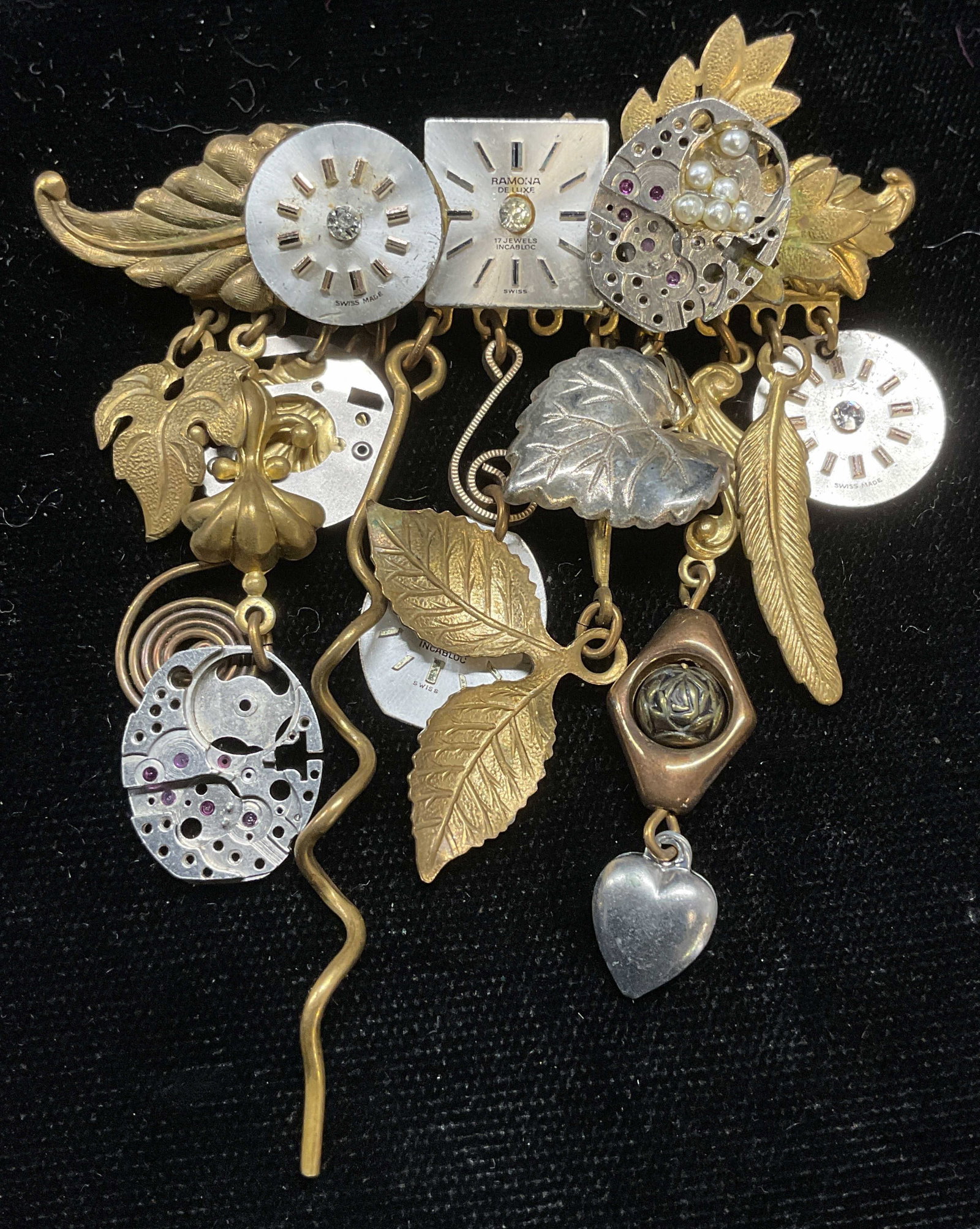 Vtg Handcrafted Watch Dial Pendant Brooch: Vintage handcrafted silver and gold tone pendant brooch with watch dials and botanical motif charms. Measures approx 2.5 x 2.75 inches. Some wear including scratching observed. Jewelry, estate jewelry