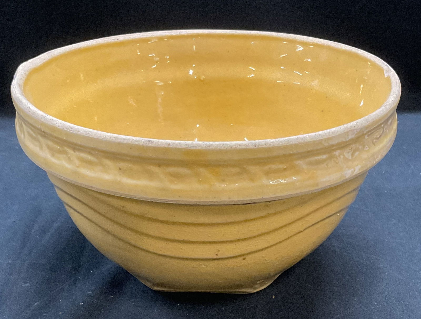 Antique Yellowware Earthenware Bowl: Antique Yellowware earthenware bowl with raised wave design. Measures approx 8.5 x 5 inches. Wear including crazing and scratching. Yellowware, Yellowware bowl, antiques, collectibles, antique bowl, t