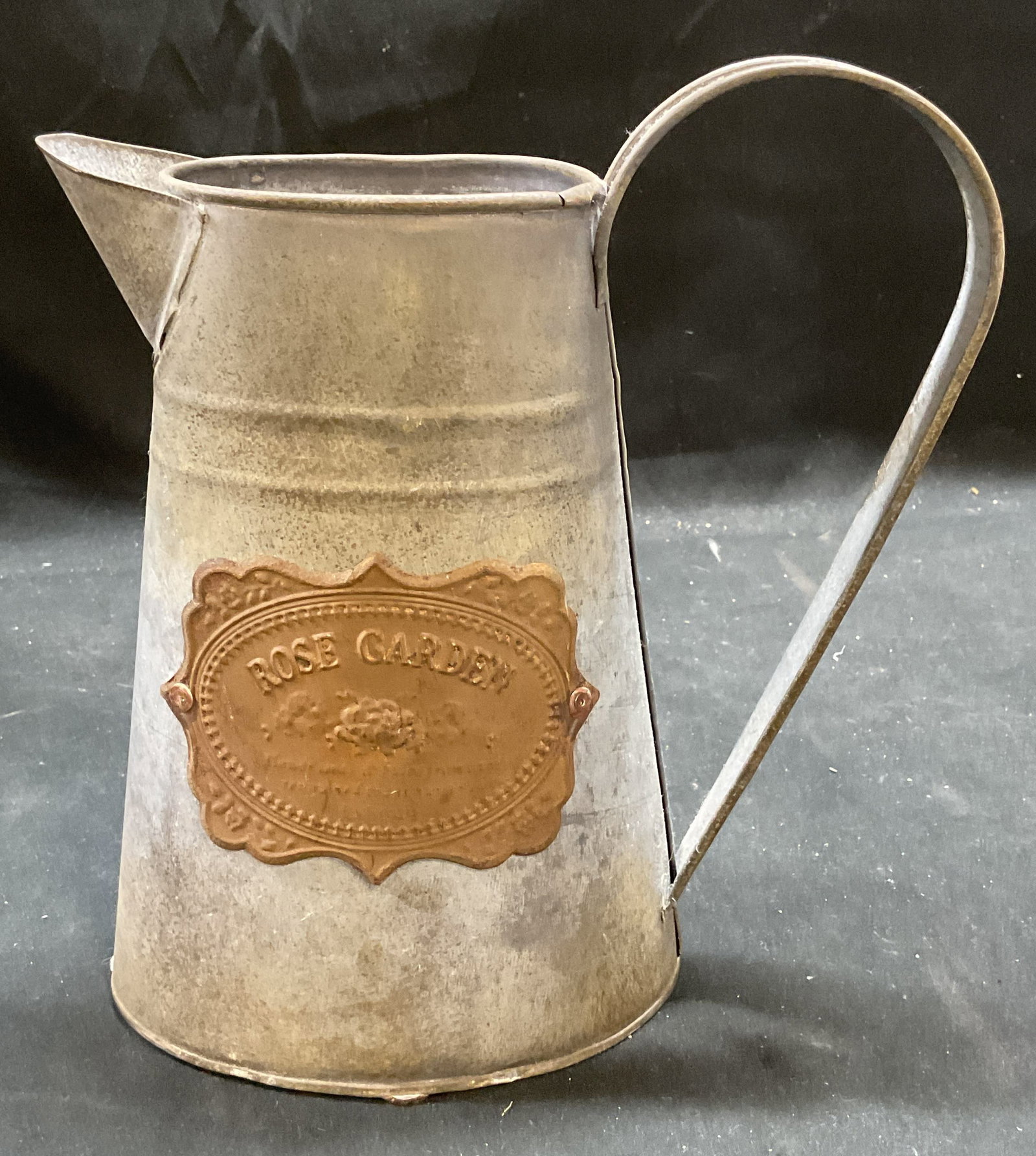 Vintage Metal Rose Garden Watering Can: Vintage metal watering can with raised plaque. Reads Rose Garden. Measures approx 8 x 4 x 8.5 inches. Surface wear including patina. Watering can, rose garden, vintage watering can, home decor, home a