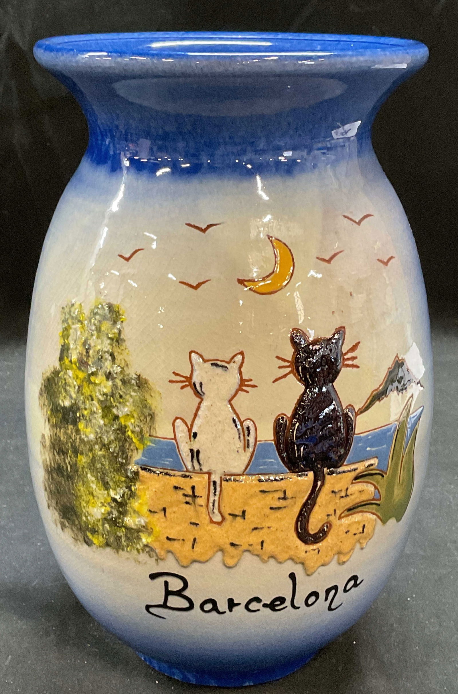 Barcelona Cats Ceramic Souvenir Ceramic Vase: Ceramic souvenir vase. Reads Barcelona. Cats and landscape. Hand painted. Measures approx 5.5 x 8.75 inches. Some wear consistent with exposure, crazing. Ceramic vase, Barcelona vase, cat vase, home d