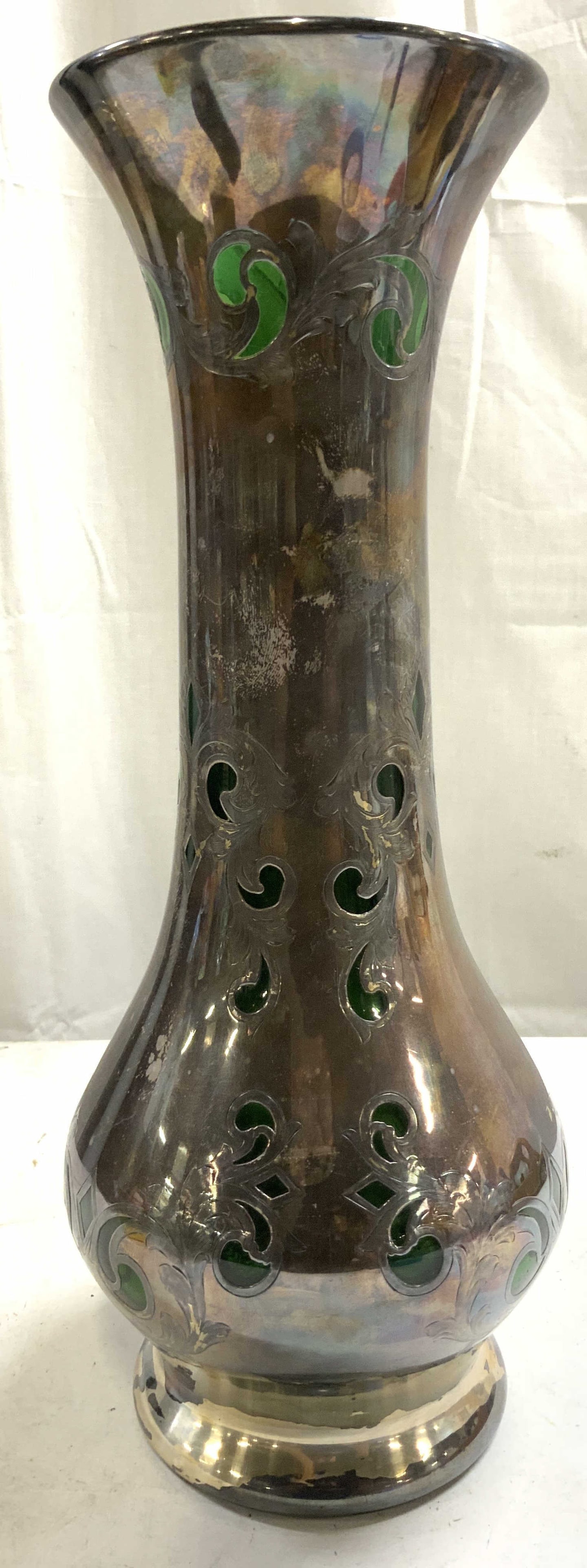 Vtg Sterling Silver Overlay Green Glass Vase: Vase has sterling silver overlay. Interior is green toned. Vase is glass. Piece appears to be vintage. Vase has scroll and leaf detail with sterling silver overlay rim. Vessel measures approximately 1