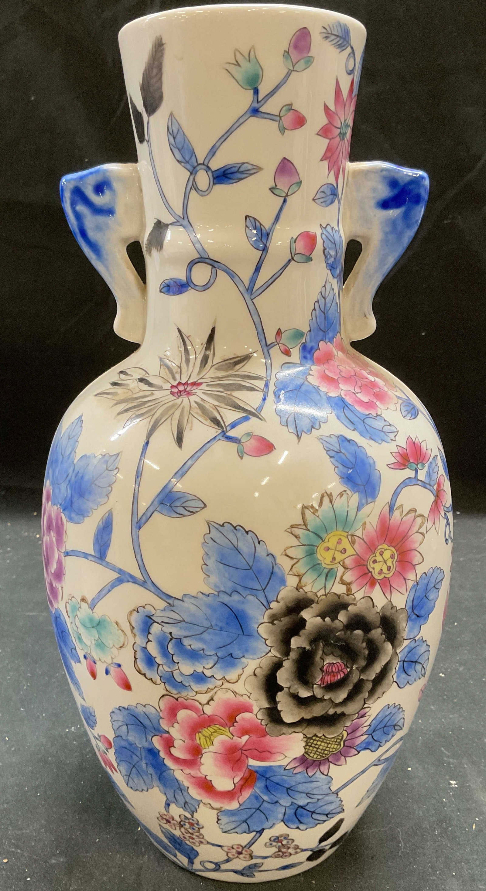 Signed Chinese Porcelain Floral Vase: Signed Chinese porcelain vase. Curved shape with decorative finials. painted with floral motifs in palette of blue, pink, and black. Measure approx 6 x 12 inches. Piece has weight. Some loss to paint 