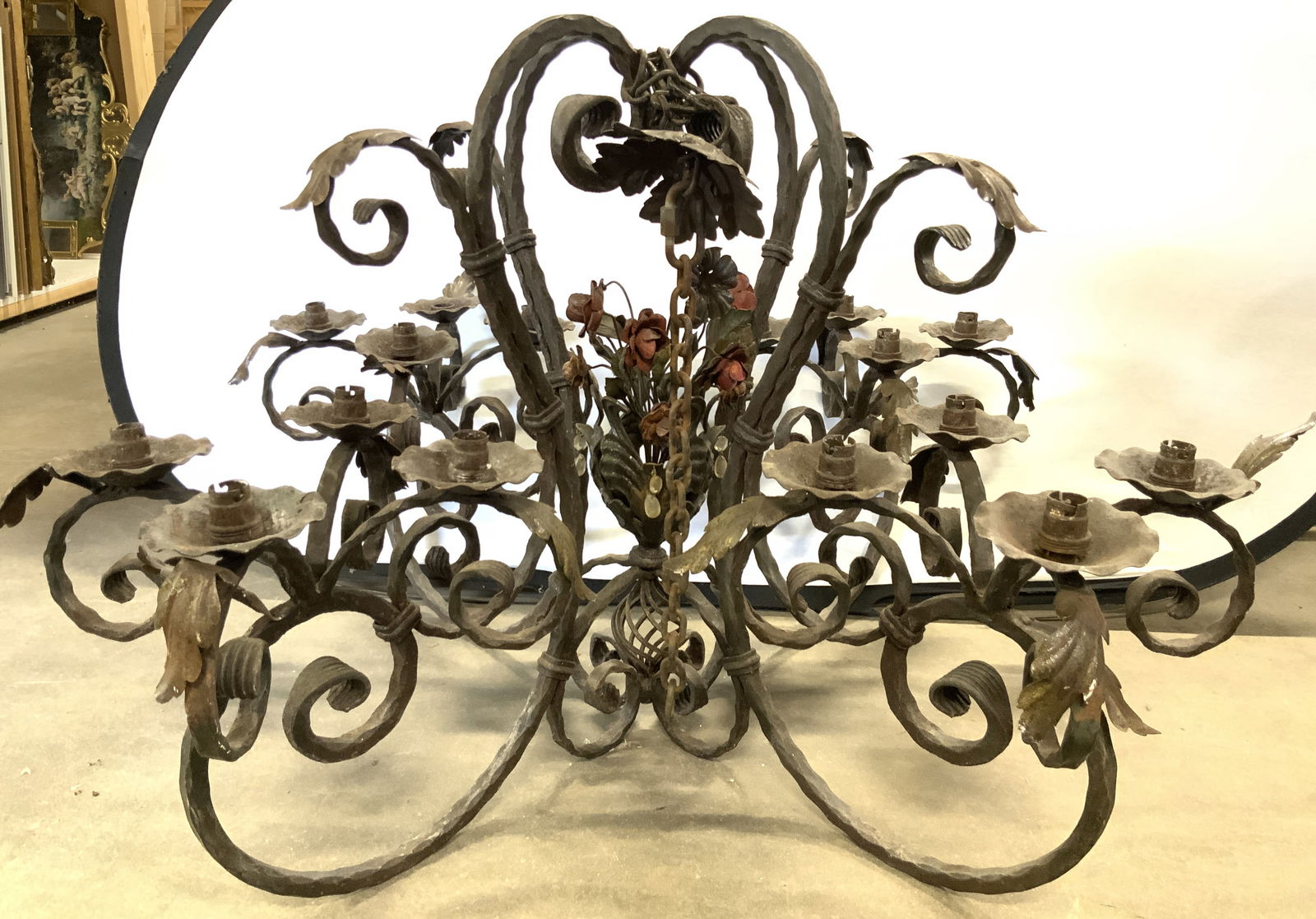 Antq Ornate Victorian 4Arm Wrt Iron Chandelier 42in: Chandelier is antique. Piece is crafted form wrought iron. Chandelier has 4 arms each with their own 4 arms. Chandelier has S scroll C scroll, floral and leaf structures. Each of each have candlestick