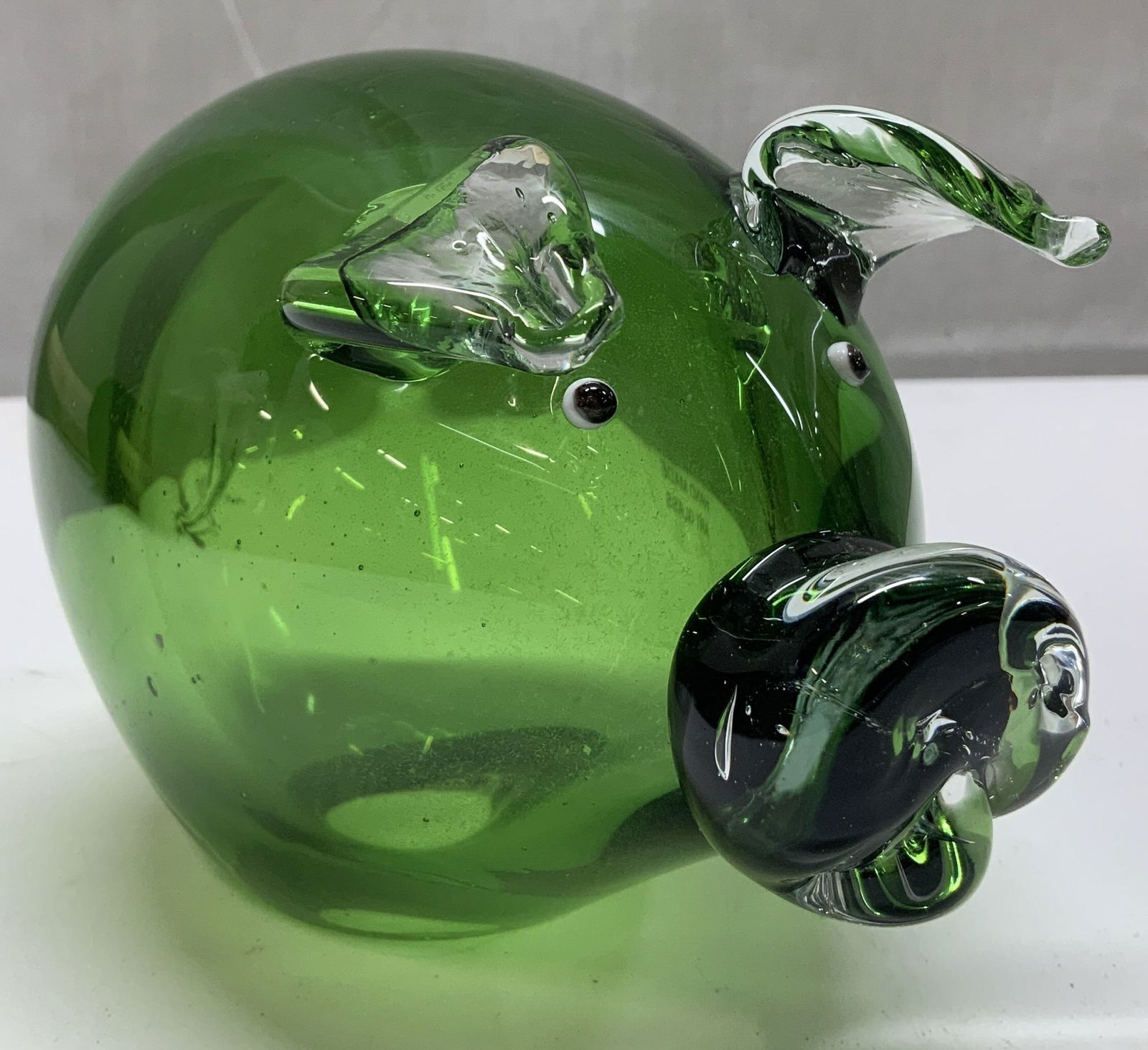 Hand Blown Green Art Glass Pig Figurine: Figurine is glass material & is hand-made. Pig is dark green toned. Visible eyes, ears, snout & tail. Signed & marked. Reads, HAND MADE ART GLASS. Surface wear consistent to age, use & exposure. Measu