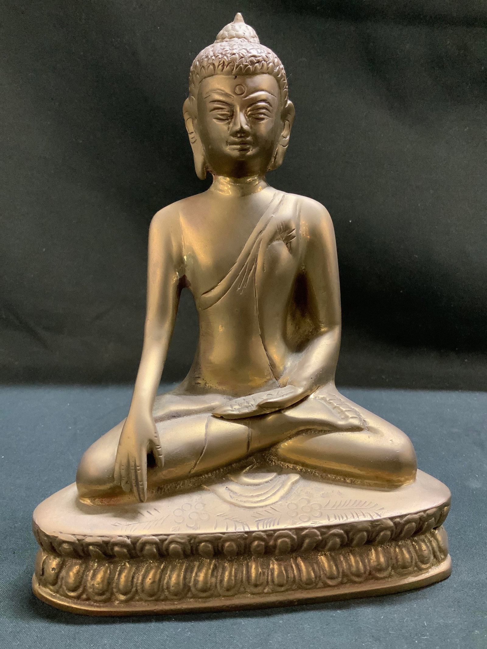 Sitting Buddha on Lotus Pedestal Brass Fig. INDIA: Figurine is brass material. Depicts a Buddha who is seated on a double lotus pedestal. Textured details. Signed & marked. Reads, MADE IN INDIA. Surface wear consistent to age, use & exposure. Measurem