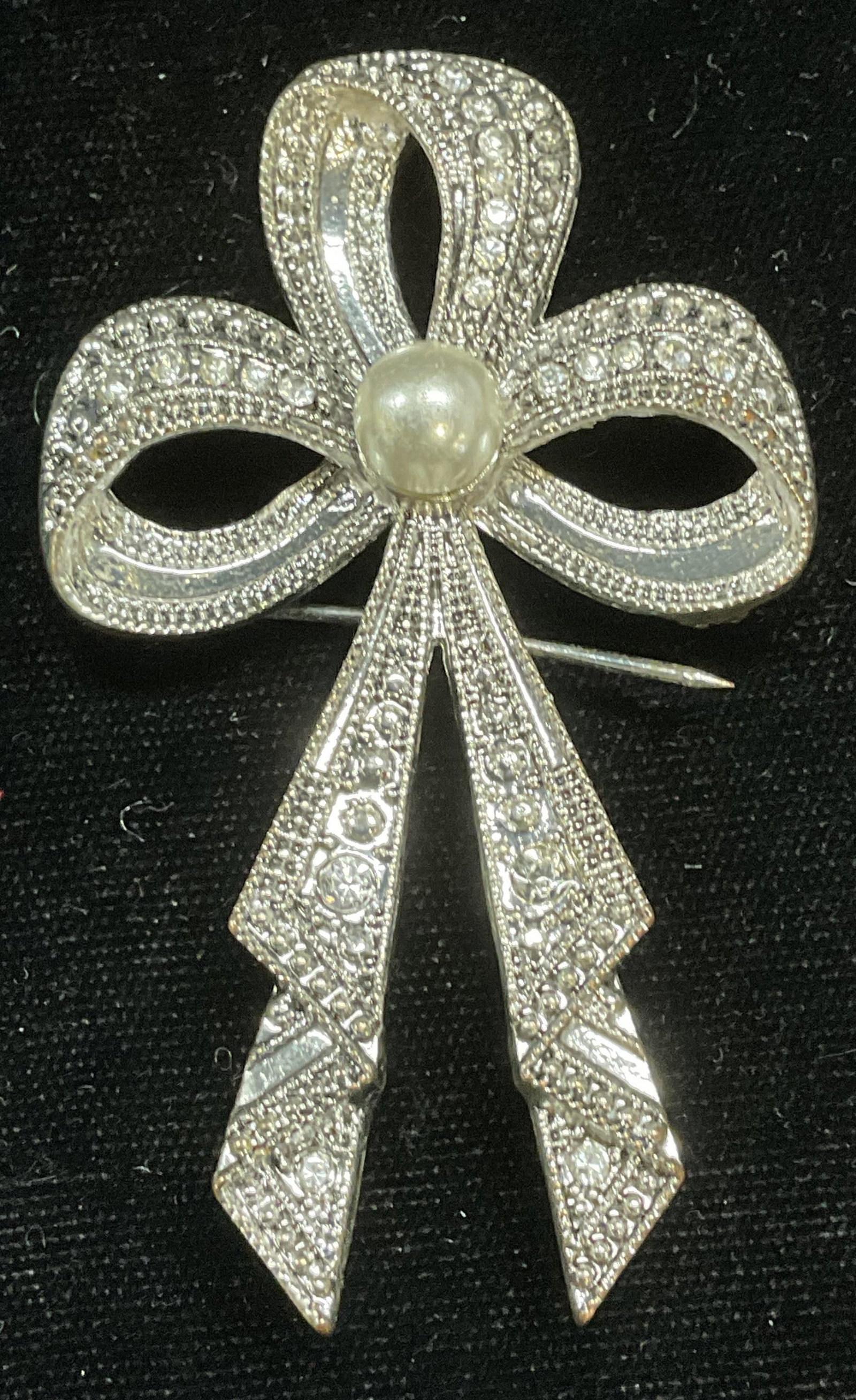 Silver Tone Crystal Faux Pearl Ribbon Brooch: Silver tone ribbon motif brooch with faux pearl and crystals. Measures approx 3 x 1.75 inches. Some scratching. Backing needs repair. Jewelry, estate jewelry, costume jewelry, cocktail jewelry, fashio