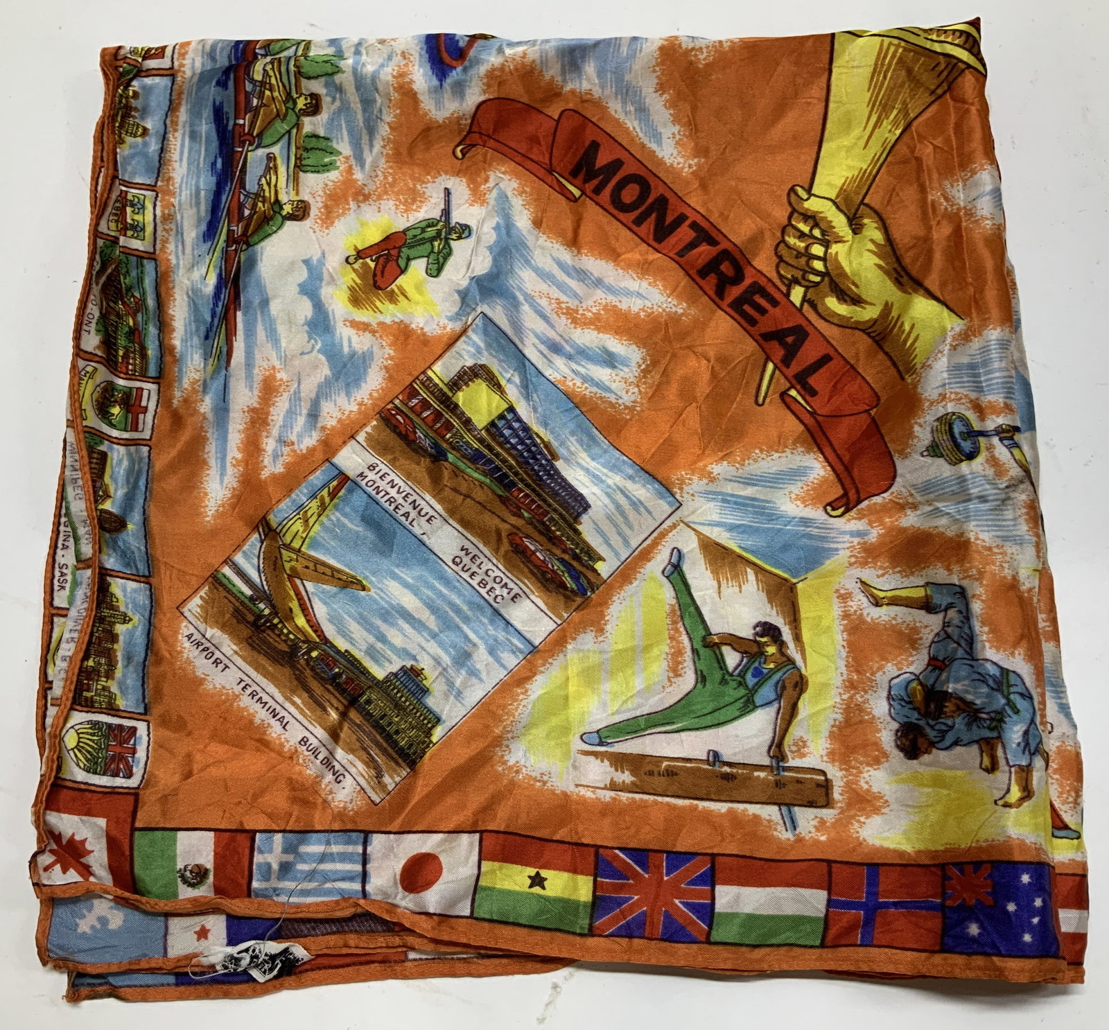 Vntg Montreal Canada Souvenir Acetate Scarf: Scarf features illustrated scenes & landmarks from Montreal & other parts of Canada. Illustrations of athletes, landscapes & buildings. Border is decorated with miniature images of cities & flags from
