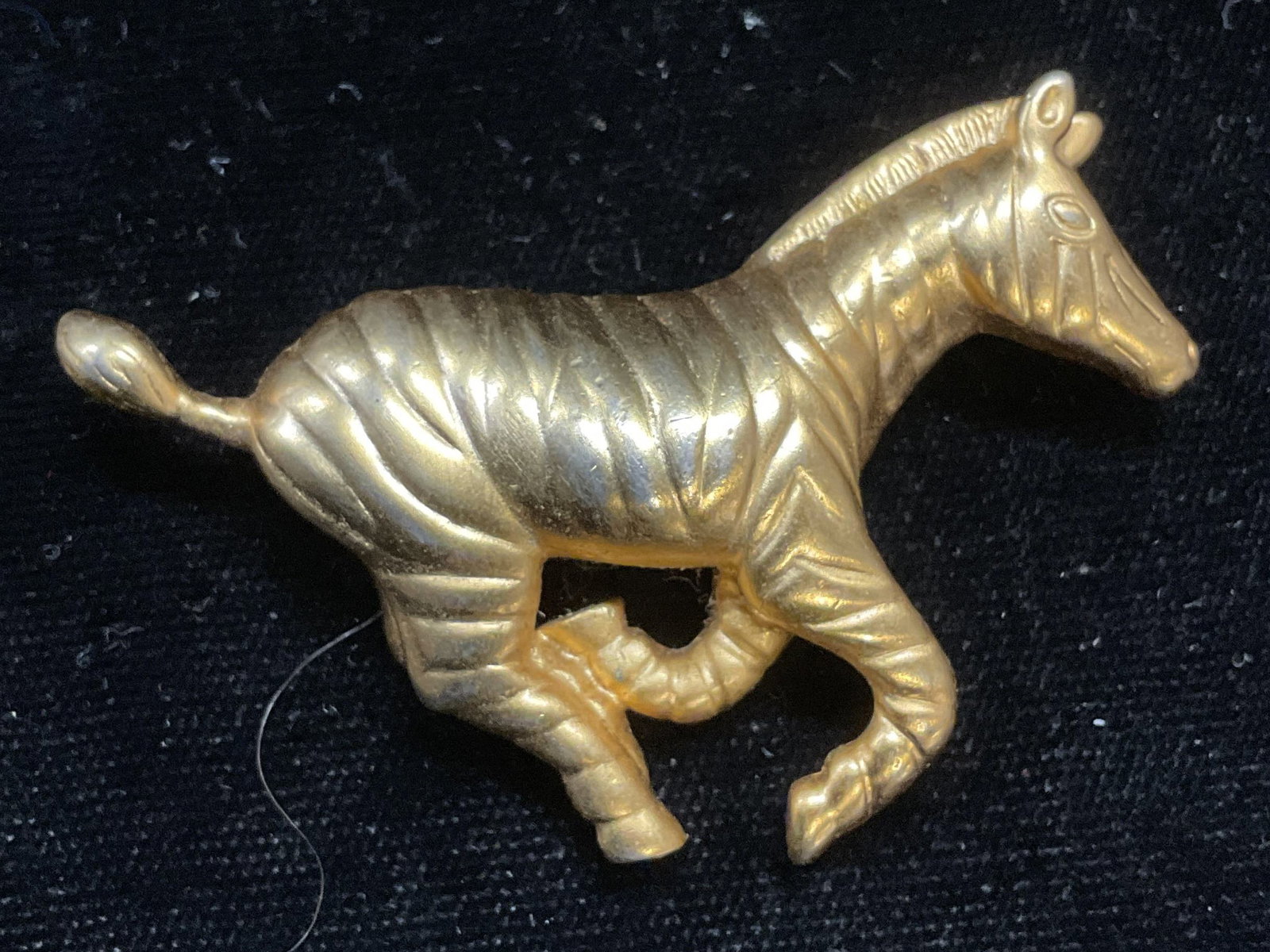 AK Gold Tone Galloping Zebra Brooch: AK gold tone galloping zebra motif brooch. Signed. Measures approx 1.5 x 2.25 inches. Some scratching. Jewelry, estate jewelry, costume jewelry, cocktail jewelry, fashion jewelry, accessories, fashion
