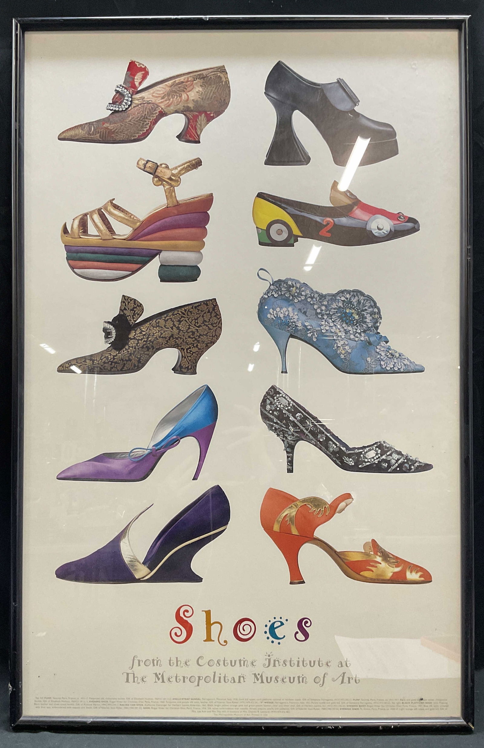 Metropolitan Museum of Art Shoes Litho Poster 35in: Framed lithograph poster on paper. Shoes from the Costume Institute at The Metropolitan Museum of Art. Printed in USA. Print date unknown. Black wood frame. Not examined out of frame. Frame measures a