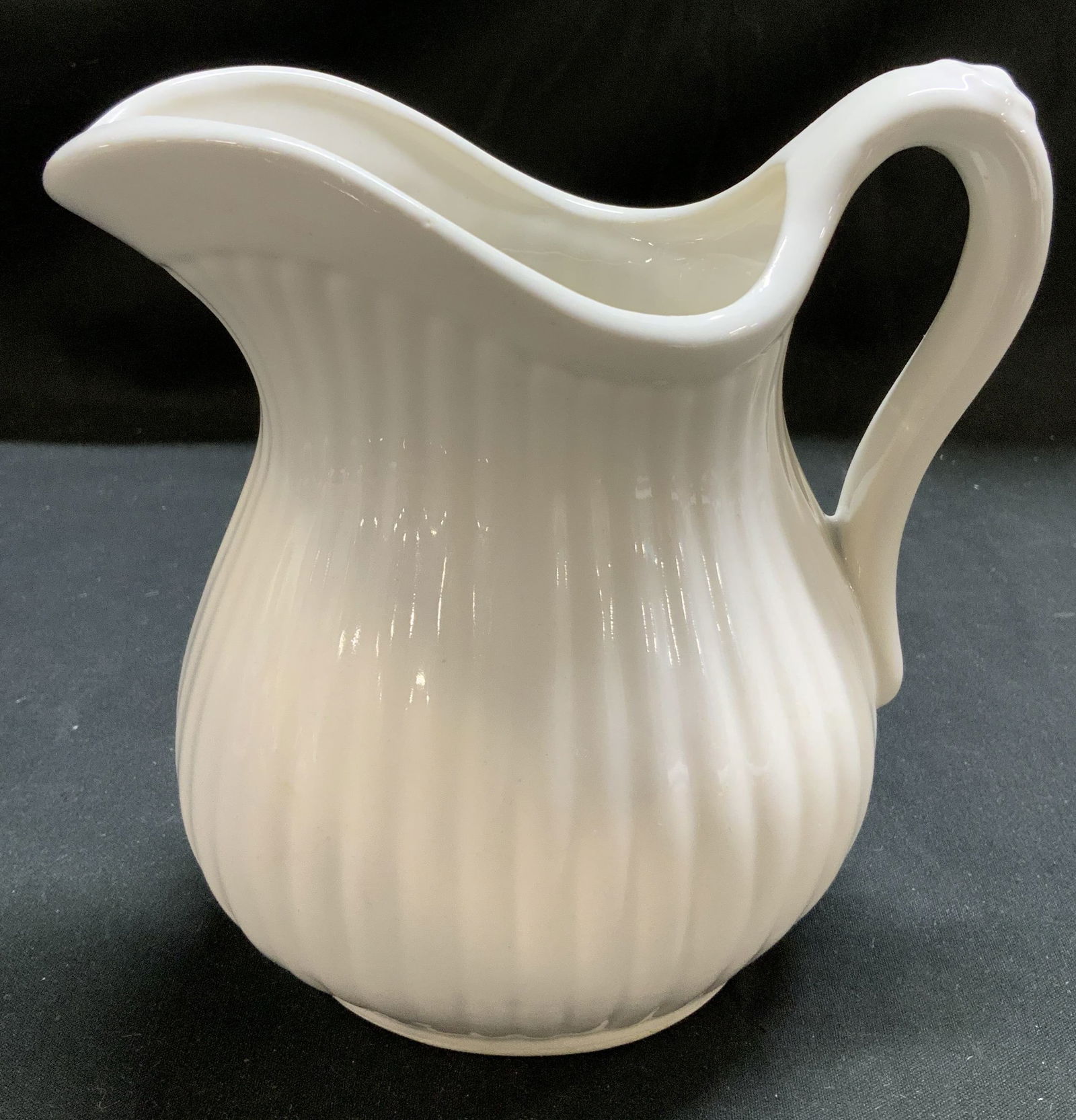 Vntg California Pottery White Ribbed Creamer USA: Creamer is ceramic material & features a vertical ribbed texture and a glossy finish. Handle has a small floral motif. Signed & marked on underside. Reads, CALIFORNIA USA. Surface wear consistent to a