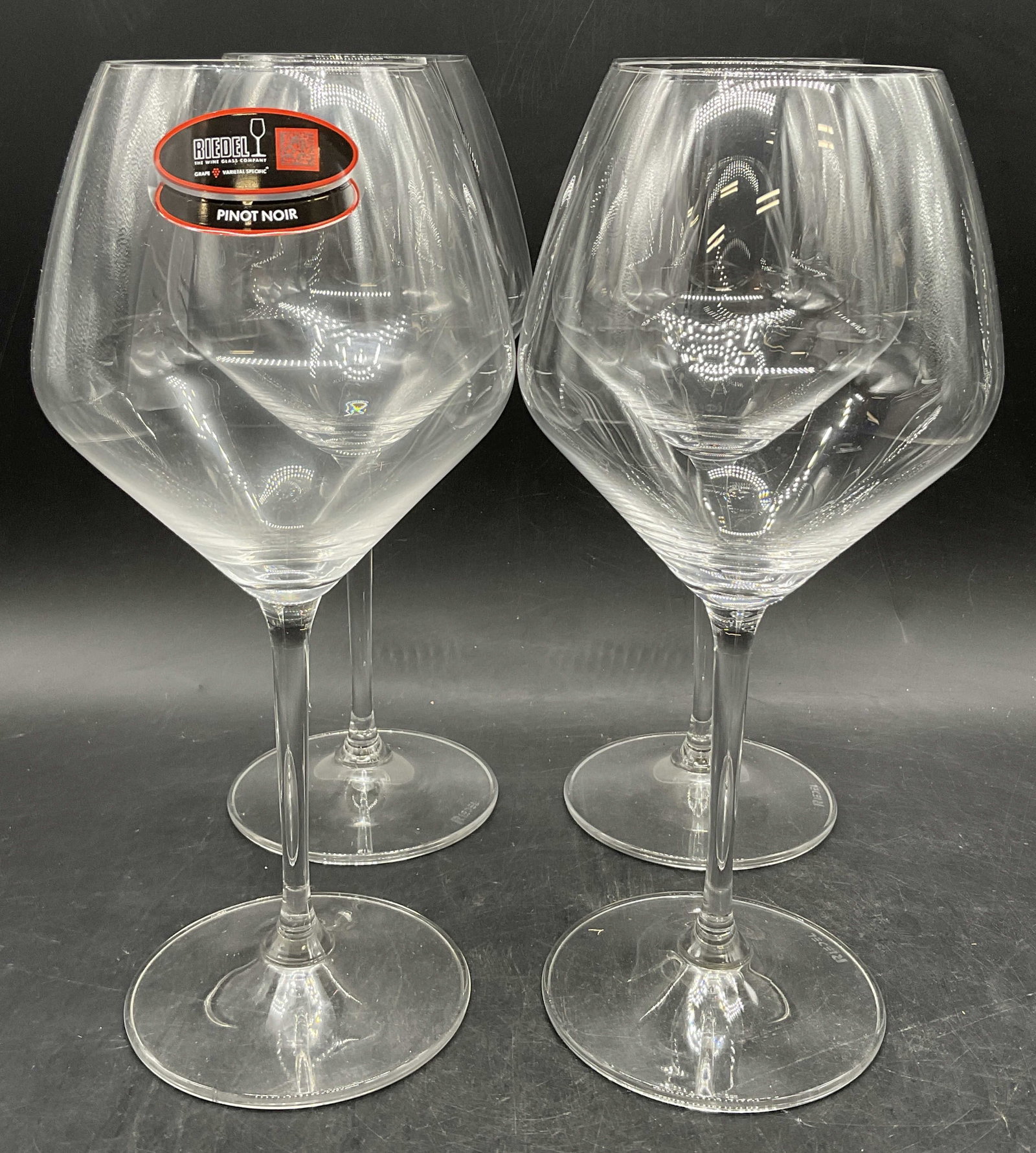 Set 4 RIEDEL Signed Crystal Stemware Wine Glasses: Set of 4 RIEDEL Signed Crystal Stemware Wine Glasses. Undersides signed RIEDEL and one possesses a sticker which reads RIEDEL PINKT NOIR. Measures approx. 9.75H x 4W in. Measured at widest point. Surf