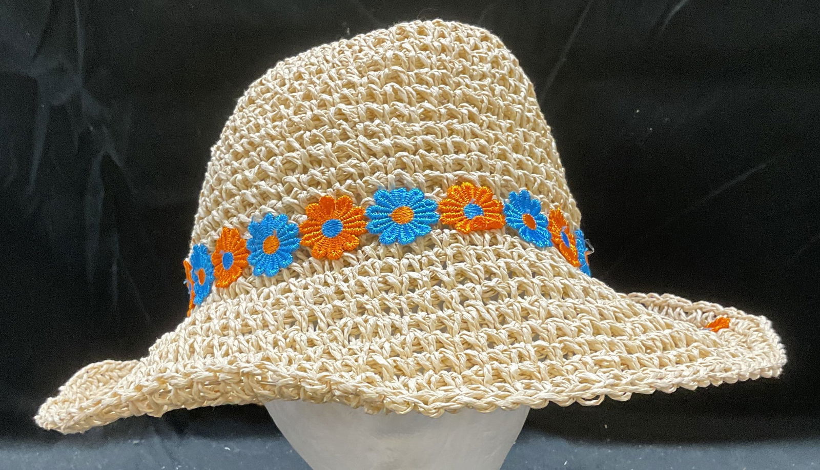 Woven Paper Straw Orange Blue Floral Hat: Woven paper straw hat with blue and orange floral trim. Measures approx 7 inches wide. Some wear consistent with exposure. Hat, woven hat, paper straw hat, floral hat, ladies hat, accessories, fashion