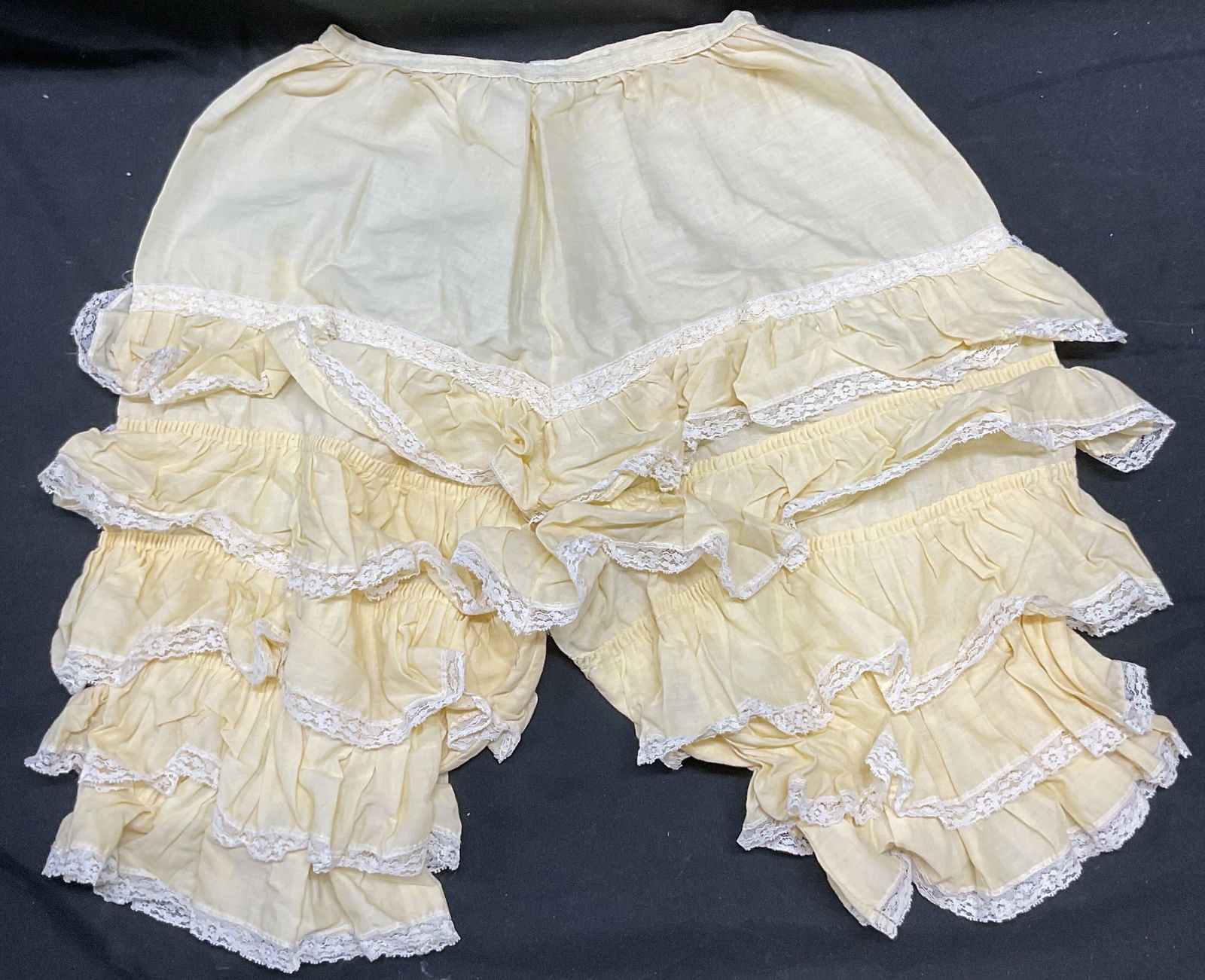 Vintage Yellow Tiered Lace Bloomer Shorts: Vintage yellow tiered lace trim bloomer intimate shorts. Feels like cotton. Elastic waist. Measure approx 10 inches across waist, 10 inch inseam. Some blemishes and small tears. Bloomer, lace bloomer,