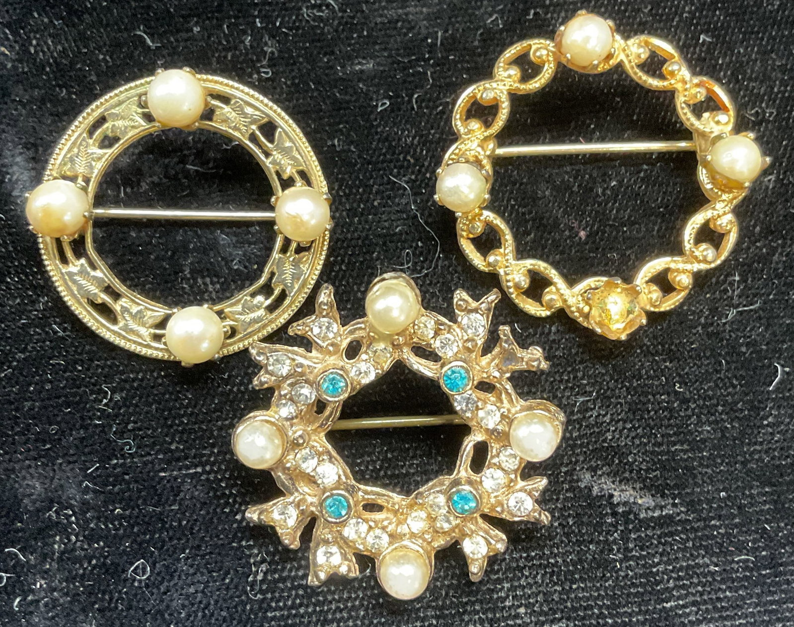 Lot 3 Gold Tone Faux Pearl Open Circle Brooches: Lot of 3 vintage gold tone open circle brooches with faux pearl and crystal decorations. Largest approx 1 1/8 inches wide. Some scratching. One pearl needs replacement. Jewelry, estate jewelry, costum