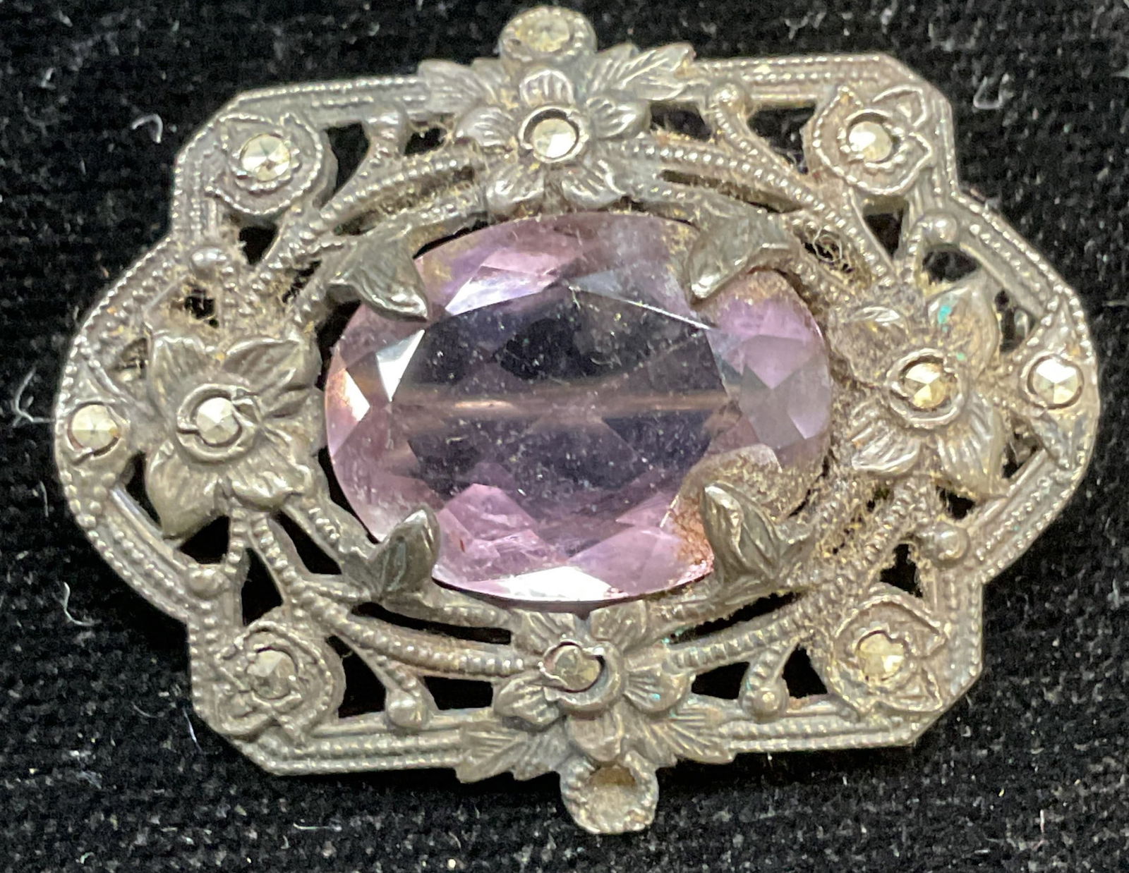 Vintage Sterling Silver Amethyst Brooch: Vintage reticulated sterling silver brooch with amethyst and marcasite, marked sterling. Measures approx 1 x 1.25 inches. Total weight 5.5 grams. One marcasite needs replacement. Some scratching. Jewe