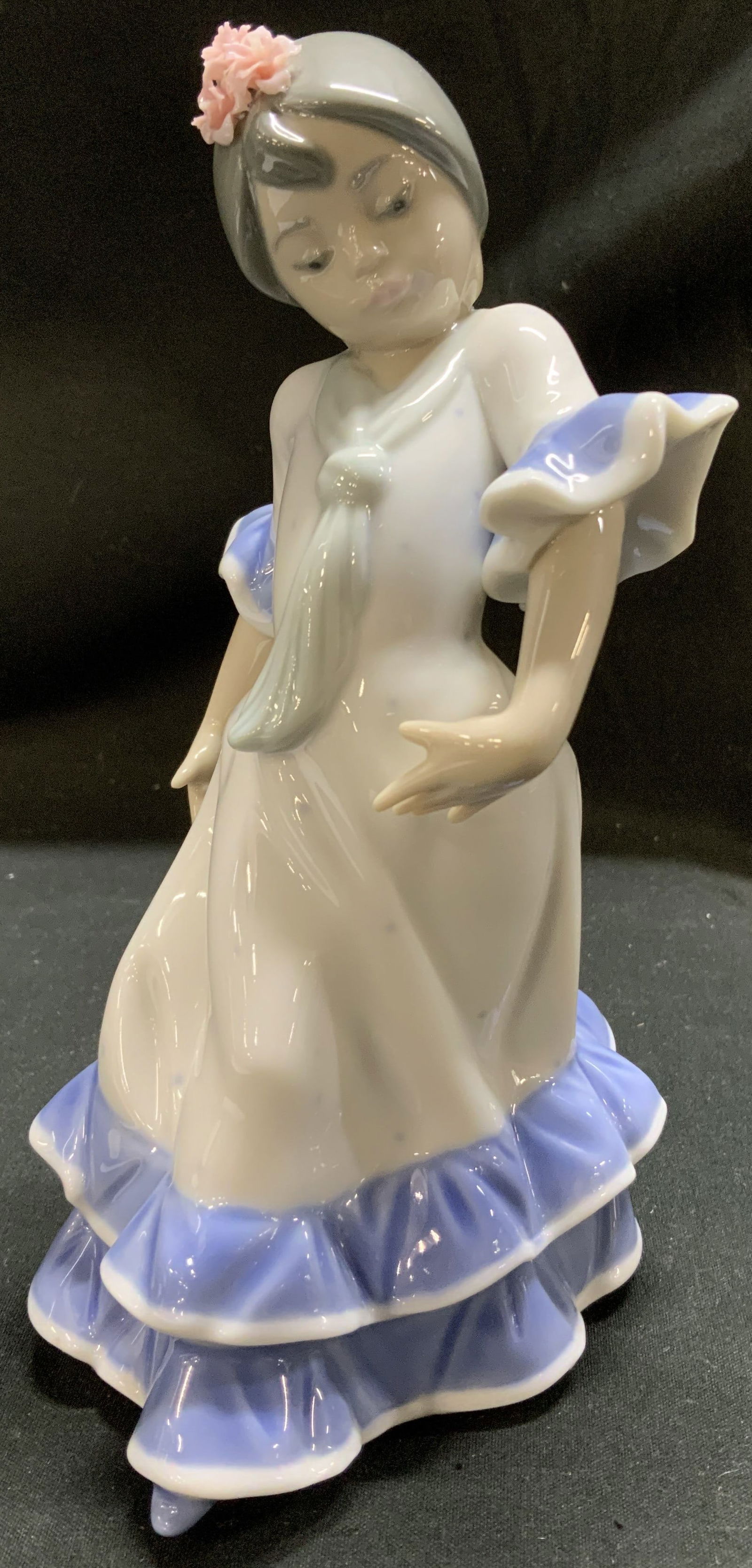 LLADRO Juanita Flamenco Dancer Porc Fig SPAIN 1983: Porcelain figurine depicts a young woman in a flamenco dancers pose, with her hands raised and her head bowed. She is wearing a white dress with blue trim on the sleeves. Signed & marked on underside.
